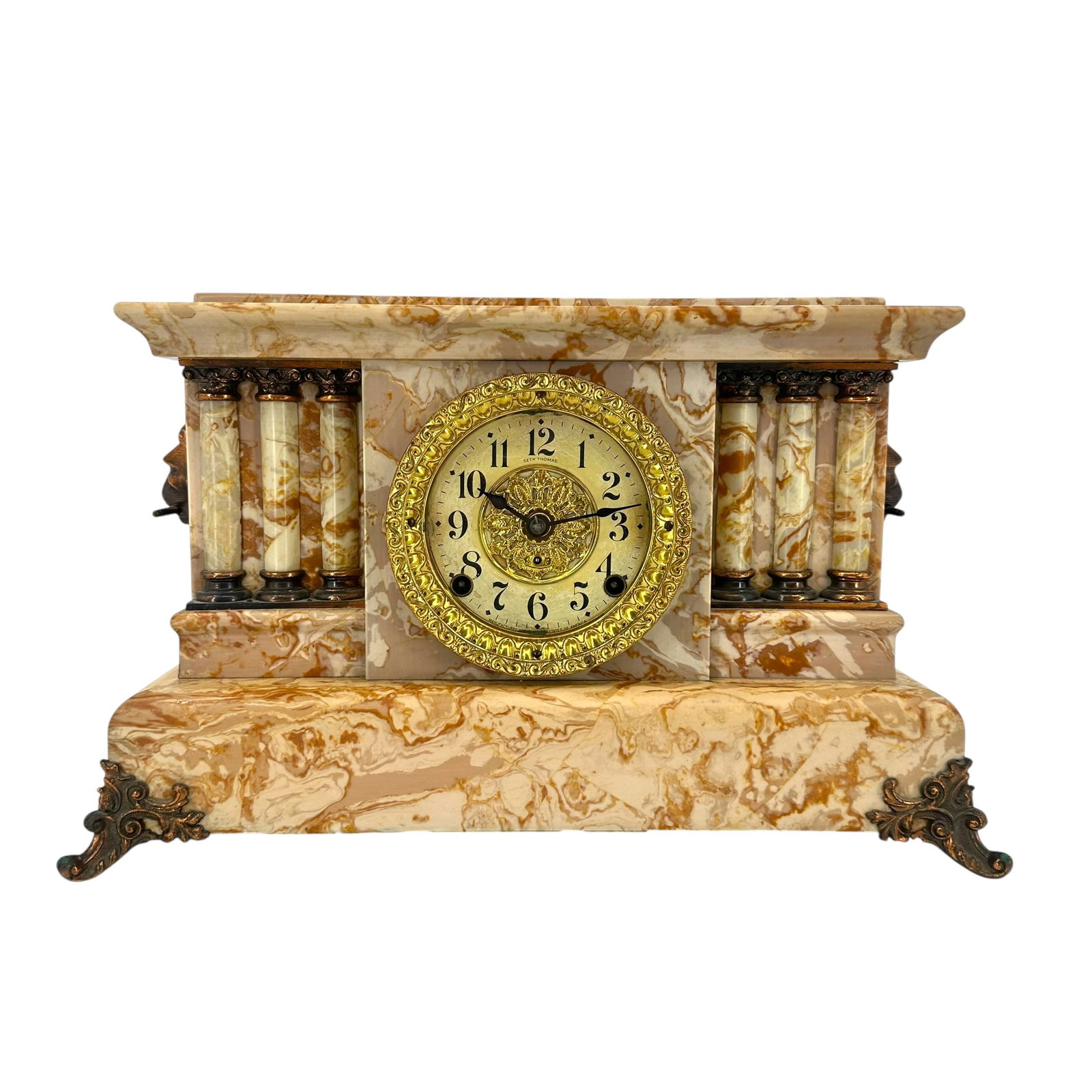 Vintage Seth Thomas Adamantine Mantle Clock: Vintage Seth Thomas Adamantine mantle clock in a faux marble case with columns on either side and brass capitals and lion's heads accents. Measures approximately 16 in W x 6 1/2 in D x 11 in T. Co