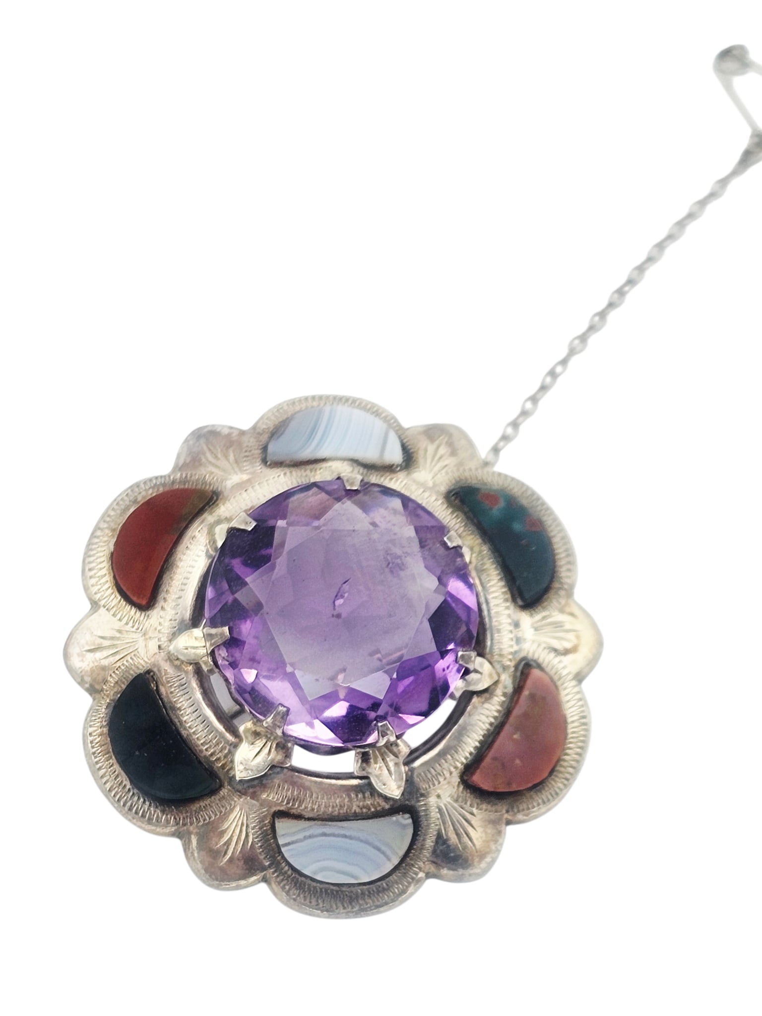 Victorian Scottish Agate, Amethyst, Sterling Silver Pin: Centering a round-cut amethyst weighing approximately 17.93 cts., accented by bloodstone, jasper, and Montrose agate, set in a circular sterling silver pin mounting measuring approximately 1.60 inches