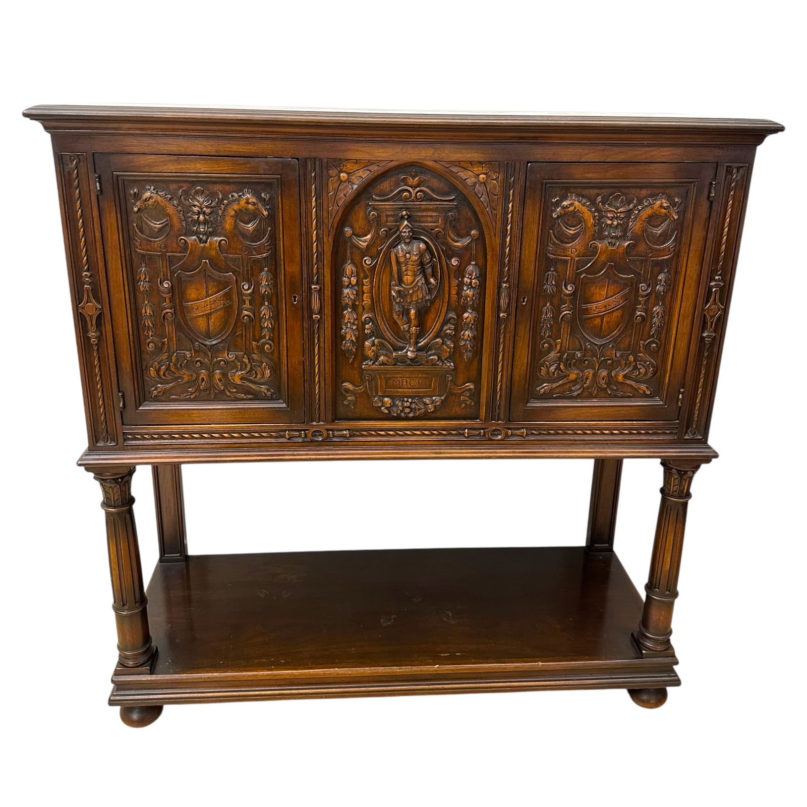 Renaissance Revival Figural Carved Cabinet: Renaissance Revival figural carved cabinet with heraldic imagery, two doors, open bottom.Measures approximately 48 in L x 18 1/2 in W x 49 in H.Condition is good overall, with some distress to the