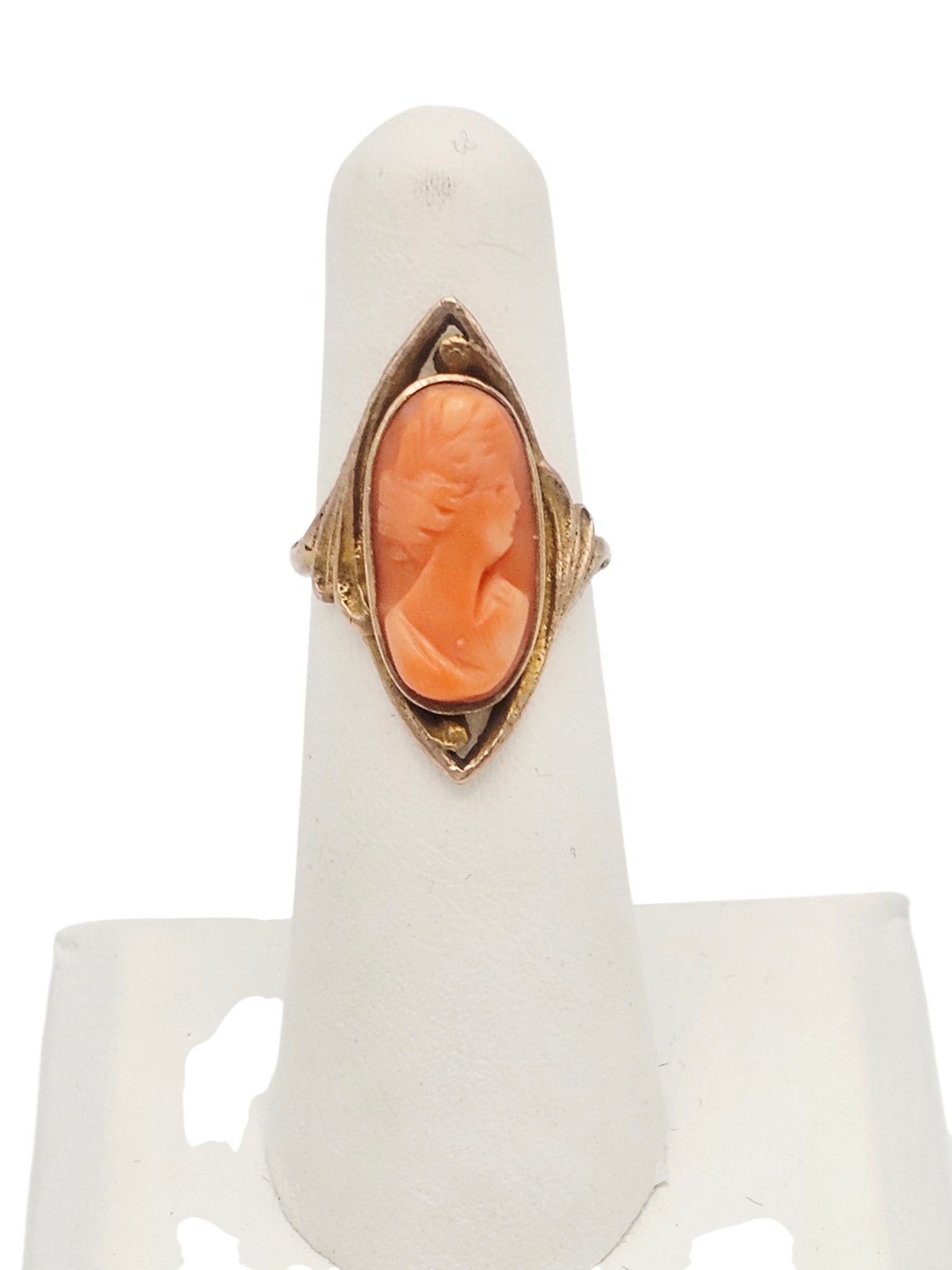 Antique Coral Cameo, 10k Yellow Gold Ring: Centering a coral cameo of a classical lady in profile, set in a scrolling, 10k yellow gold ring mounting, size 4 3/4. Gross weight: 4.3 grams.
