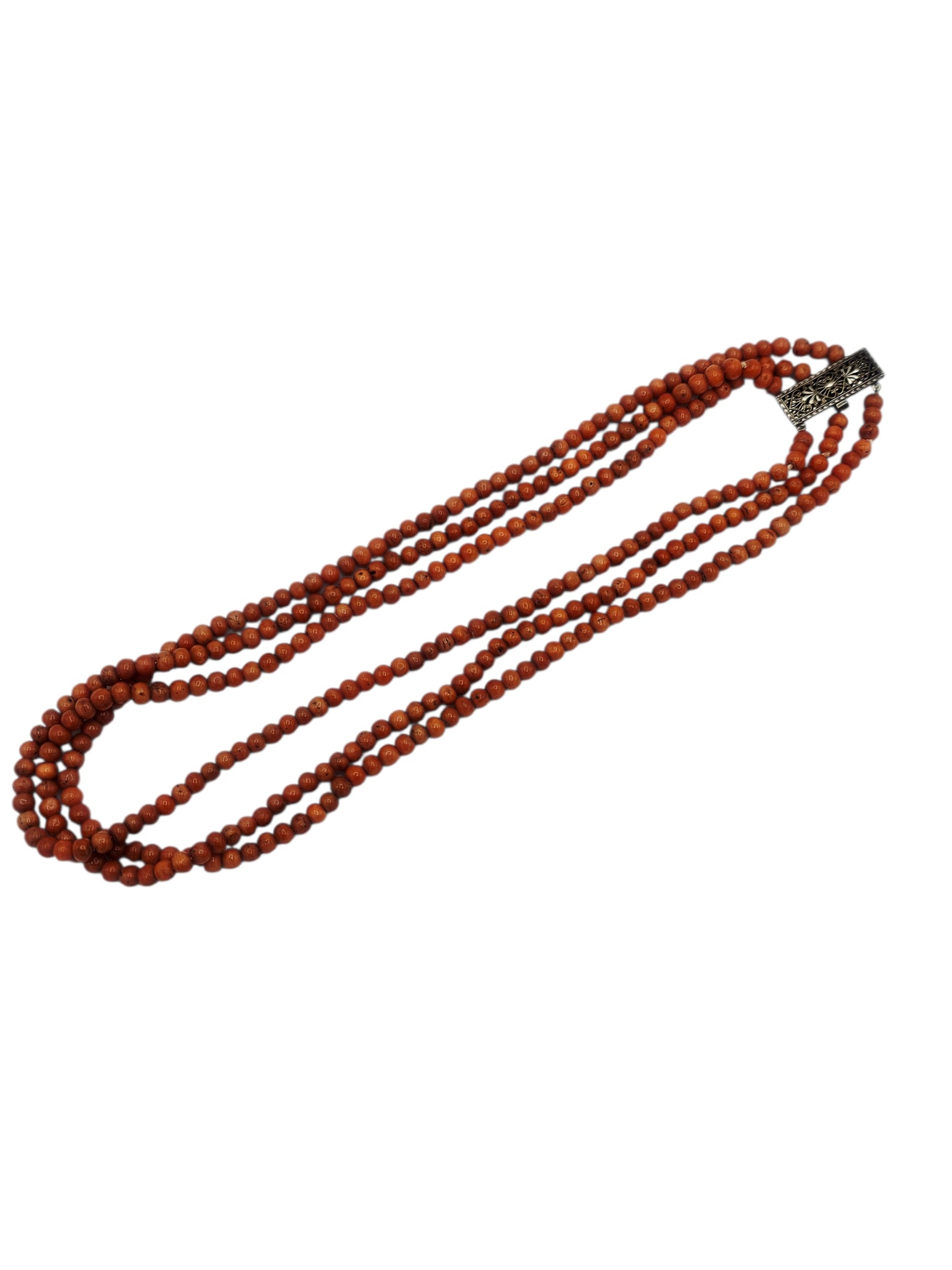 Coral, Sterling Silver Necklace: Composed of numerous off-round coral beads measuring approximately 4.6 to 4.0 mm, joined by a sterling silver tongue-and-groove clasp forming a triple strand, 16 inch necklace. Gross weight: 38.9