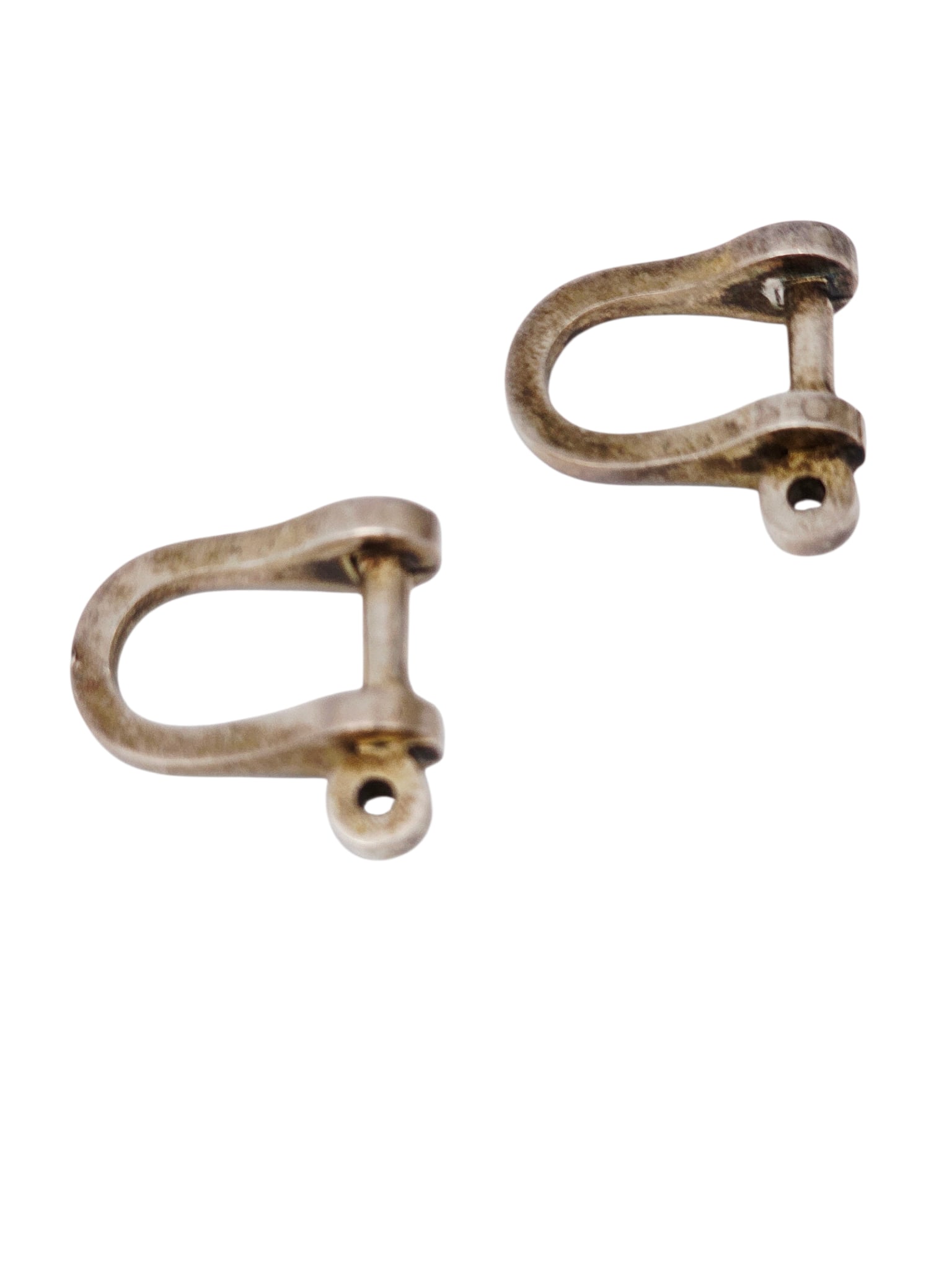 Pair of Danish Mid-Century Sterling Silver Cufflinks, Ole Lynggaard: The sterling silver 'shackle' cufflinks, each measuring approximately 1.00 x 0.90 inches. Marked: 'Ole L, 925, S, Demark. Gross weight: 18.5 grams.