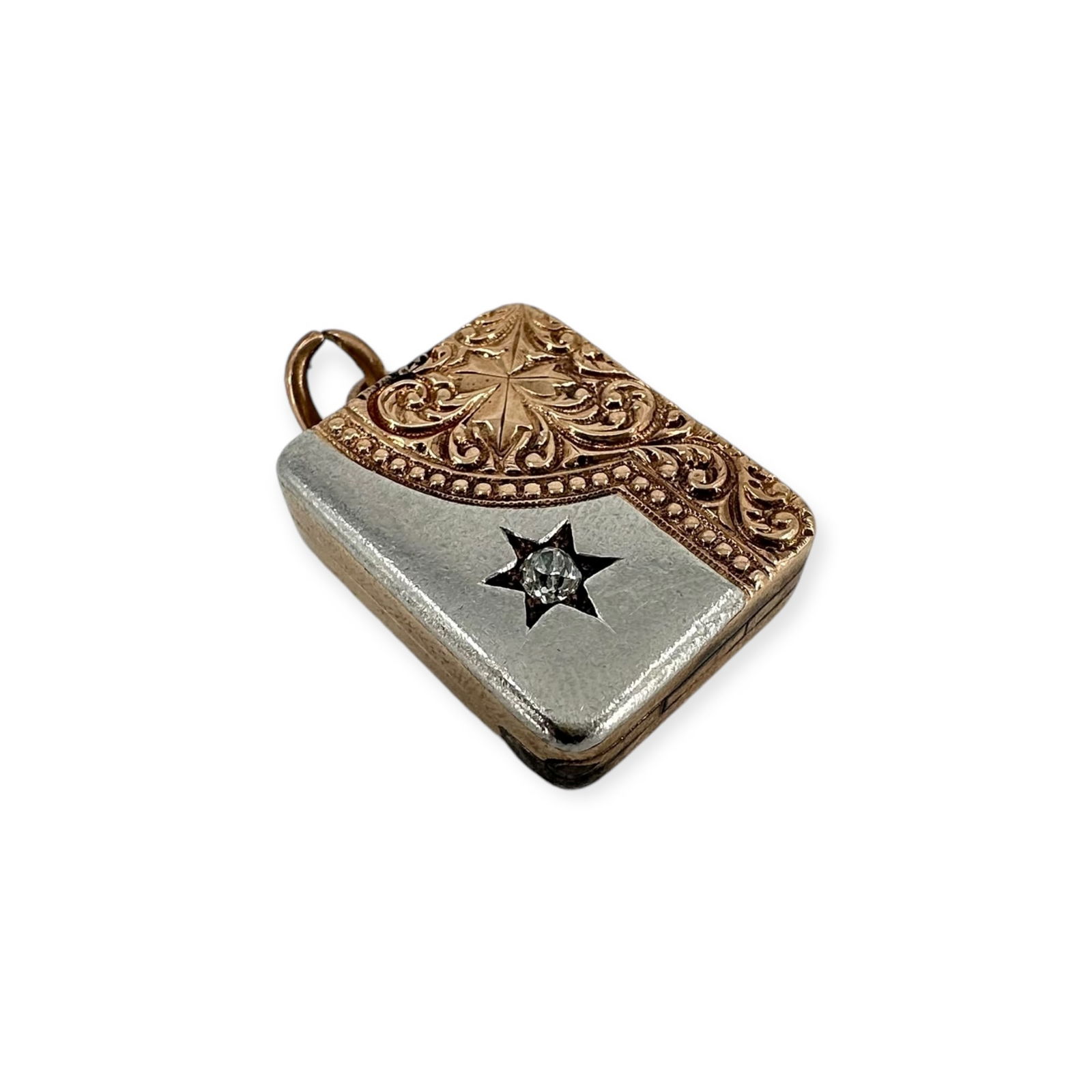 Victorian Diamond, 10k Rose and White Gold Locket: Featuring an old European-cut diamond weighing approximately 0.12 ct., accented by a oanel of scrolling vines and leaves, set in a 10k yellow and white gold locket mounting measuring approximately
