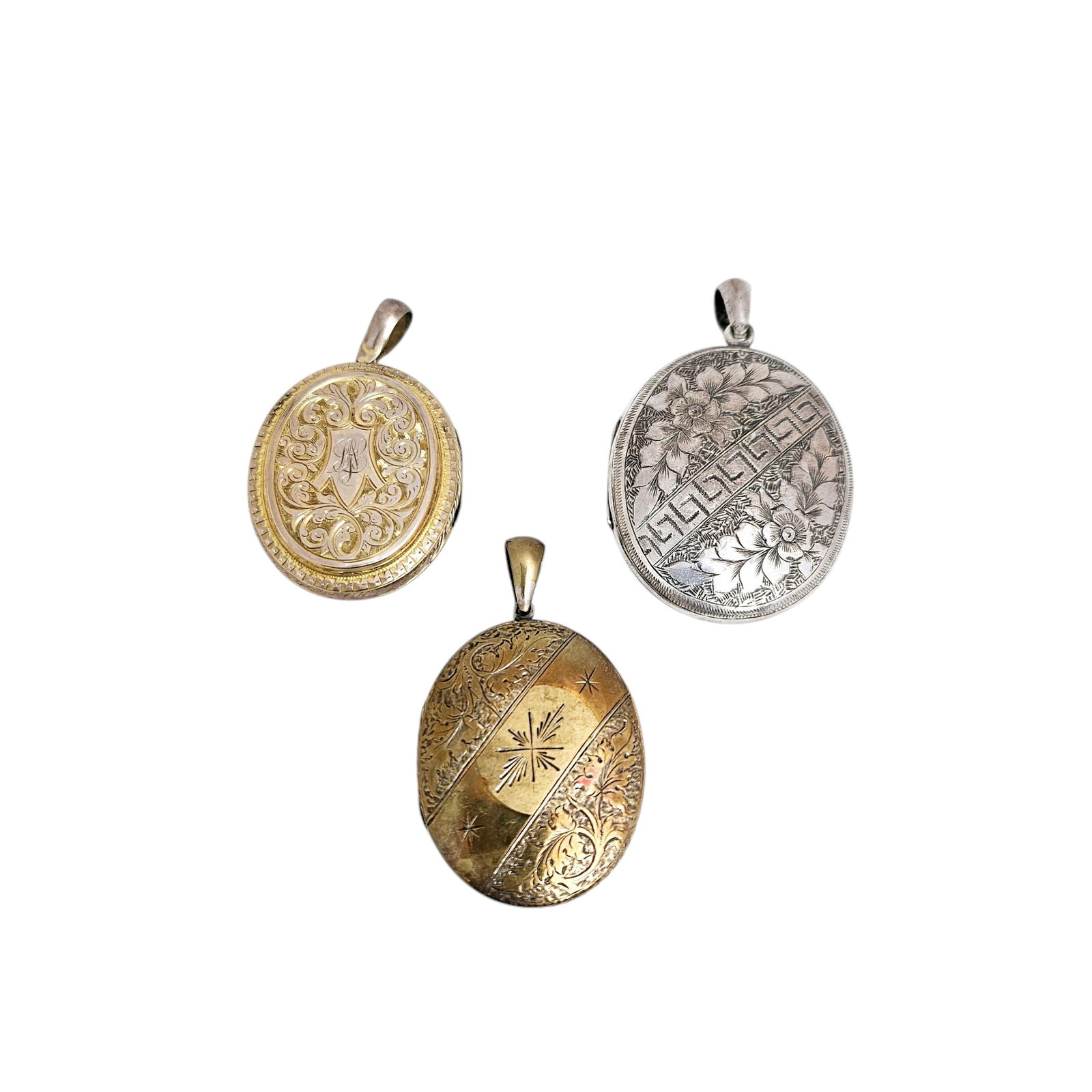 Collection of Three Victorian Silver, Vermeil Lockets: Including one sterling silver, engraved with flowers bisected by a geometric border, measuring approximately 2.56 x 1.60 inches; one vermeil, engraved with leaves and a garter, measuring