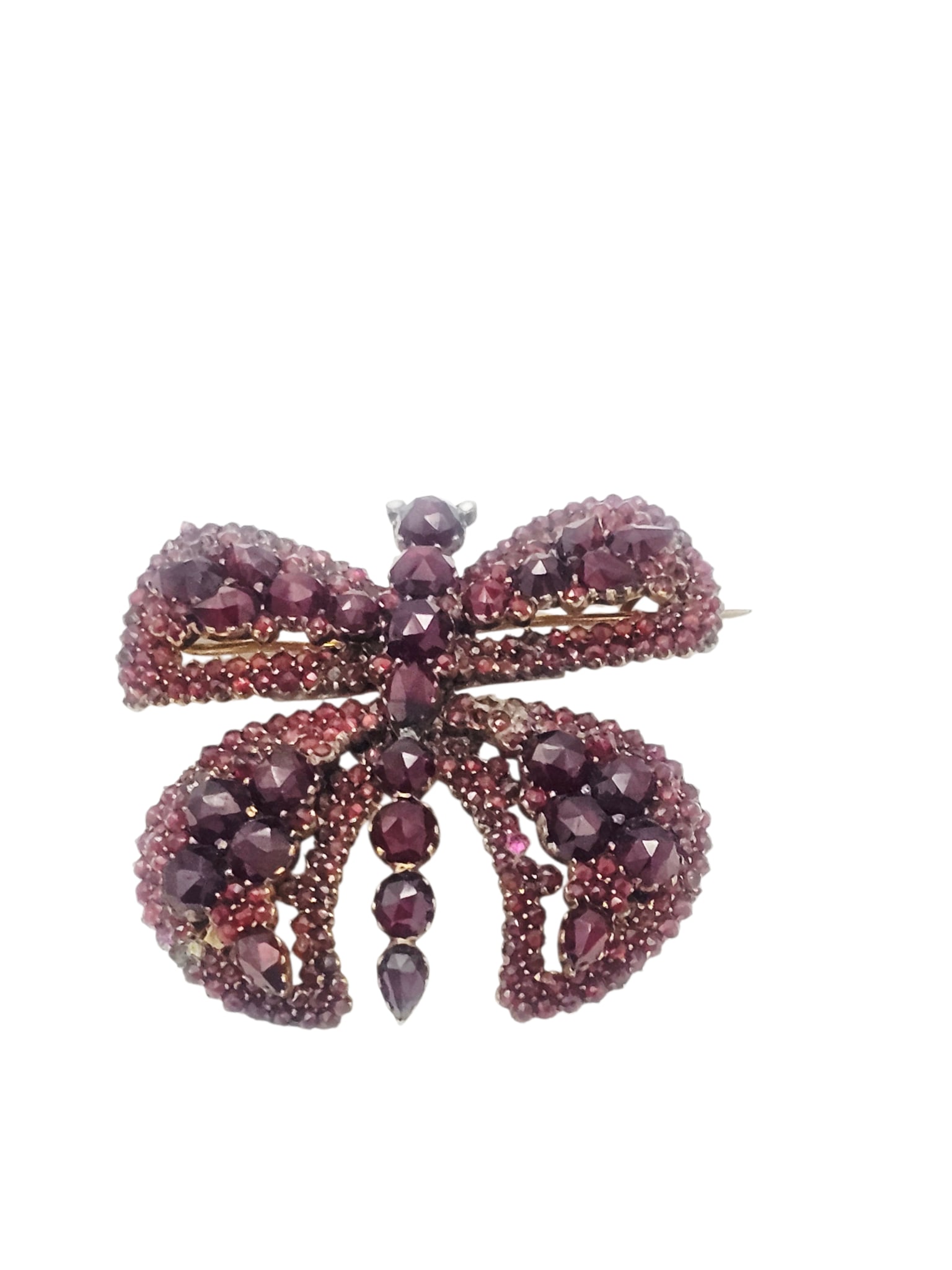 Victorian Bohemian Garnet, Silver Gilt Butterfly Pin: Designed as a butterfly accented by numerous rose-cut Bohemian garnets, set in a silver gilt pin mounting measuring approximately 1.80 x 1.75 inches. Gross weight: 14.9 grams.Condition: three garnets