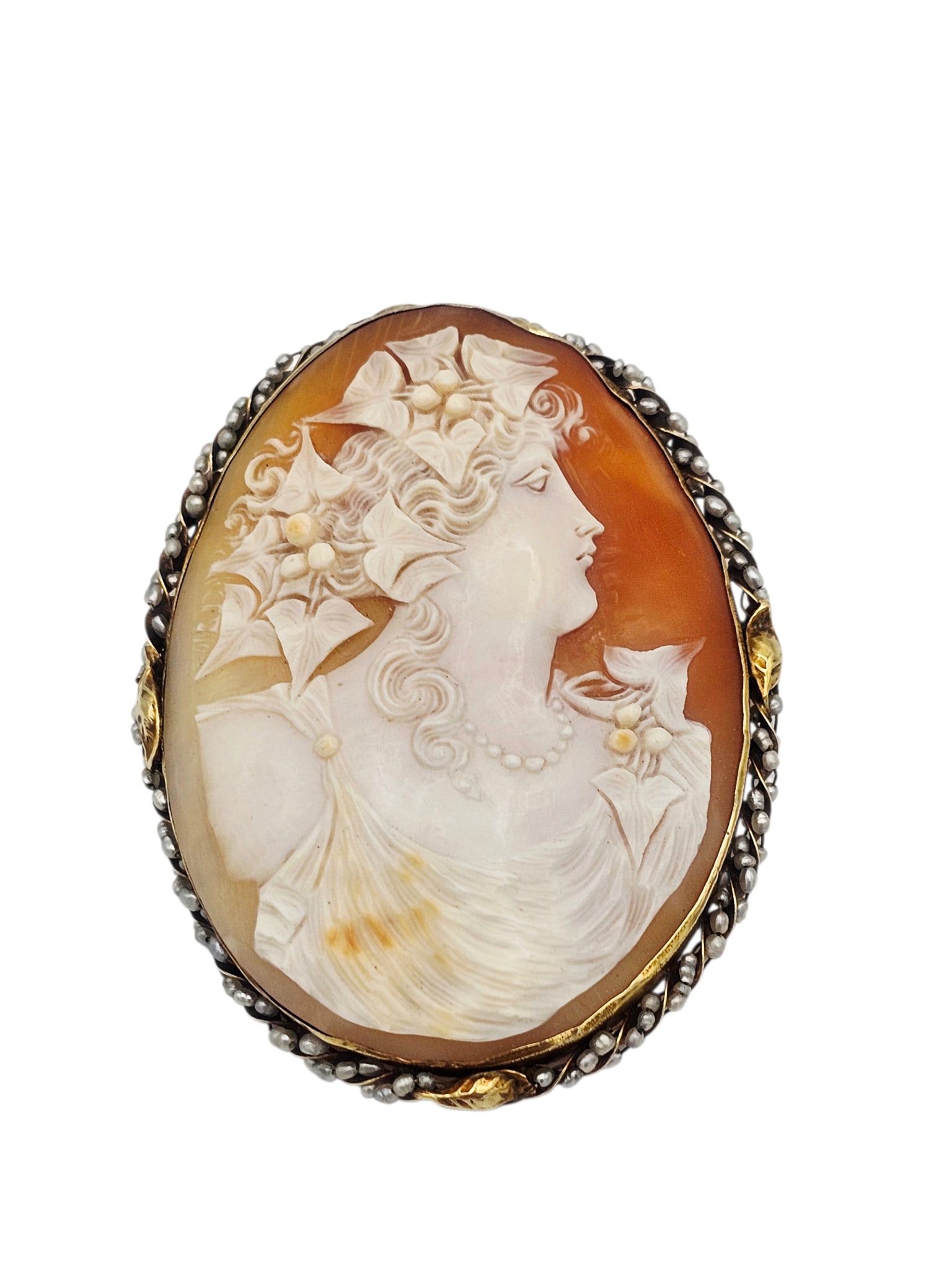 Shell Cameo, Seed Pearl, 14k Pin: Featuring an oval shell cameo of a Bacchante, framed by baroque pearls, set in a 14k yellow gold pin mounting measuring approximately 2.60 x 2.05 inches. Gross weight: 24.2 grams. Note: clasp is