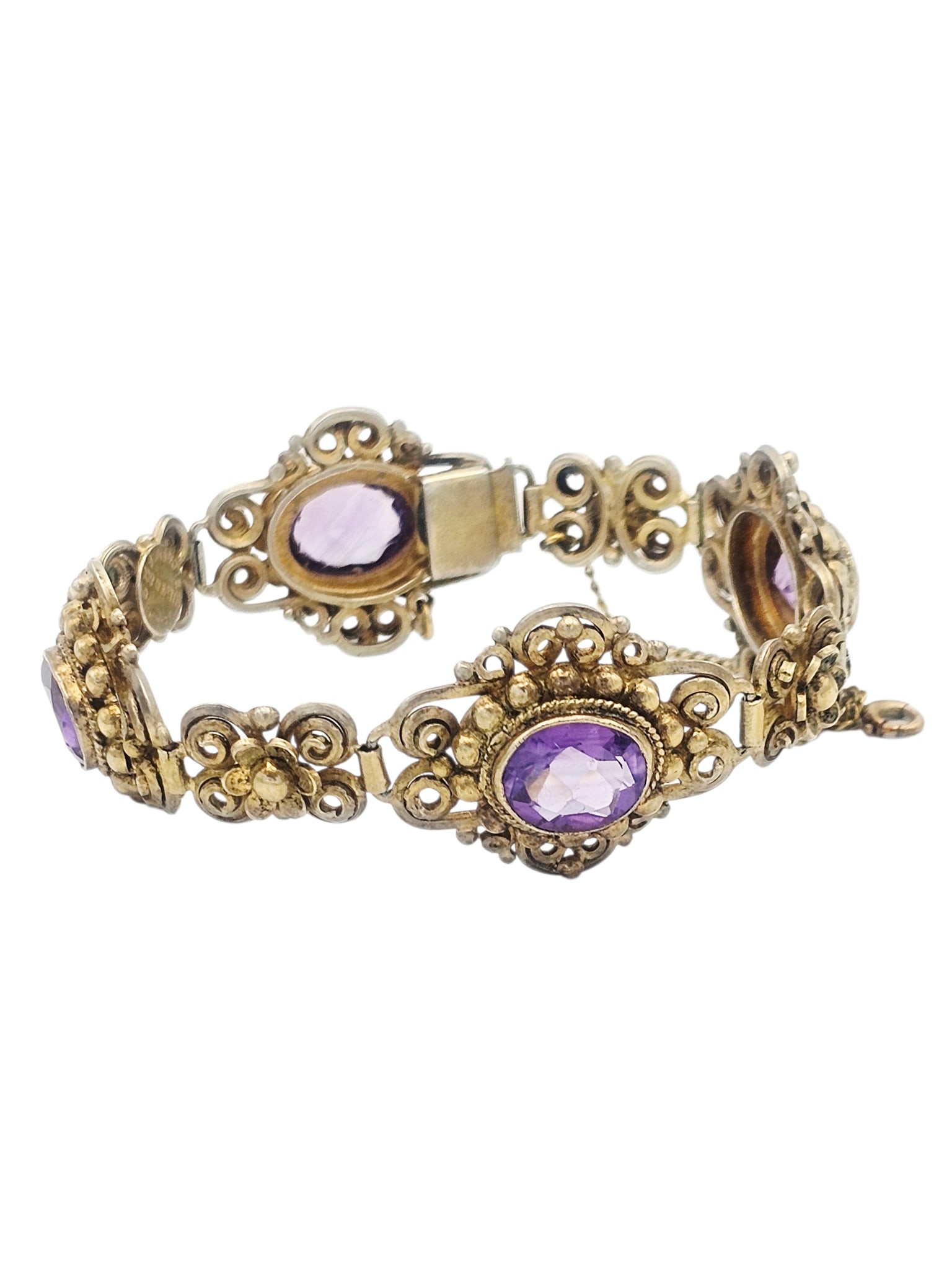 Amethyst, Silver Gilt Bracelet, Cellini: Featuring four oval amethysts weighing a total of approximately 16.25 ctw., set in beaded and scrolling silver gilt links, completed by a push-button box clasp with safety chain, forming a 7 1/4 inch