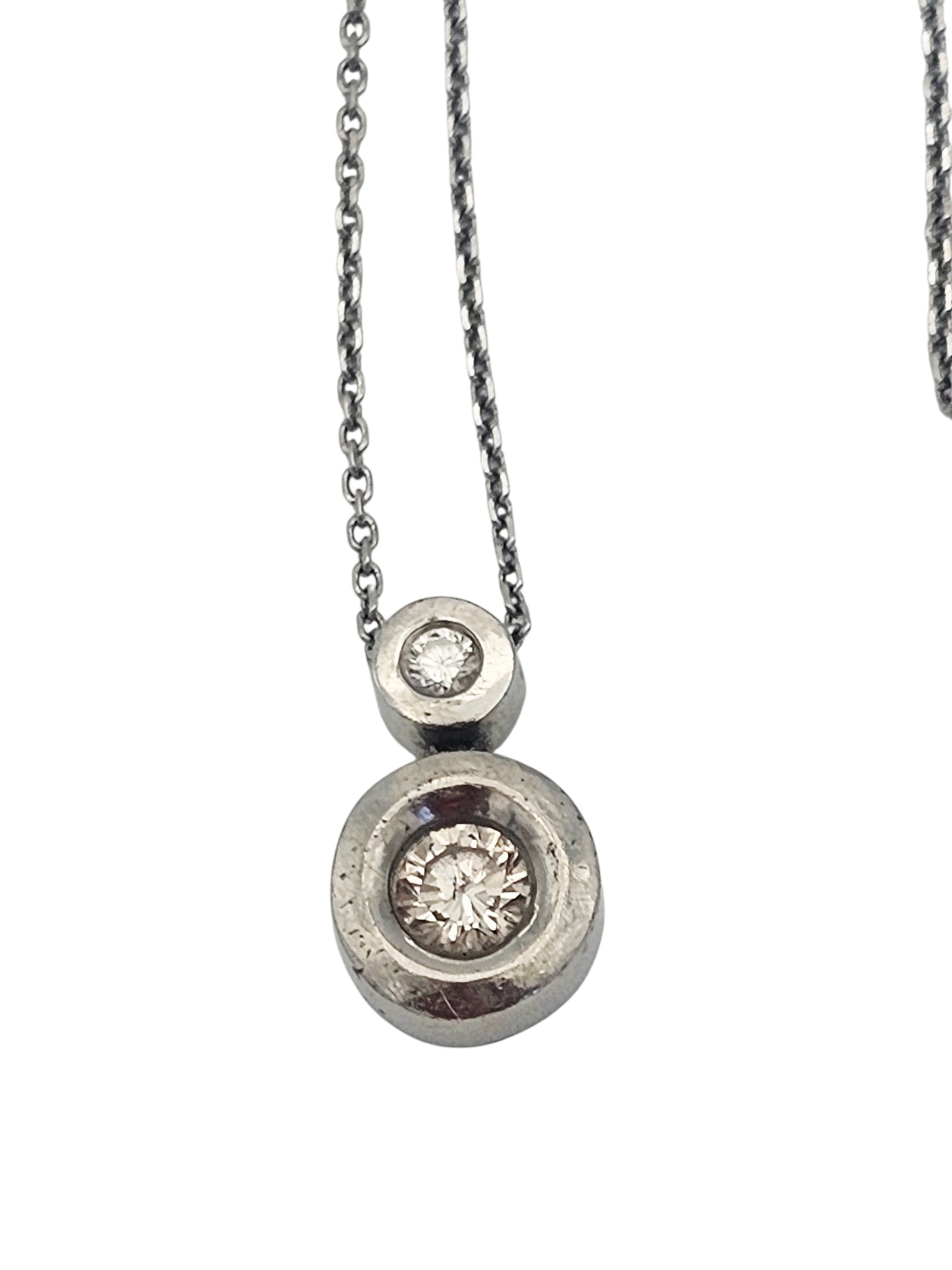 Diamond, 18k White Gold Necklace: Featuring two round brilliant-cut diamonds weighing a total of approximately 0.38 ctw., set in an 18k white gold pendant mounting, suspended by a 16 inch, 18k white gold cable link chain. Gross