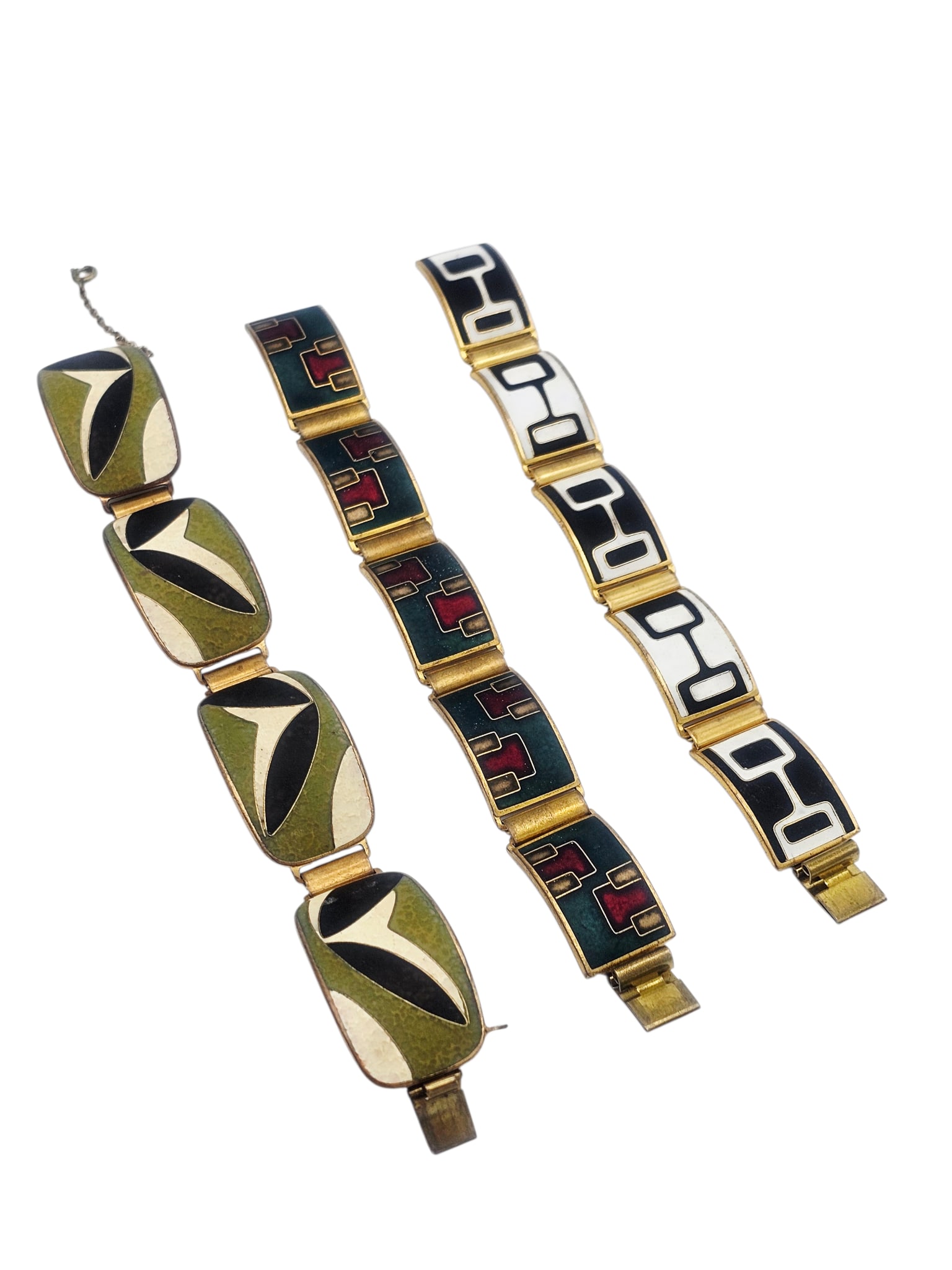 Collection of Three Modernist Enamel, Brass Bracelets, Karl Schibensky: Including one polychrome enamel, brass bracelet, 6 1/2 inches; one black and white enamel, brass bracelet, 6 1/2 inches; together with one olive green, black and off-white brass bracelet, 7 inches.