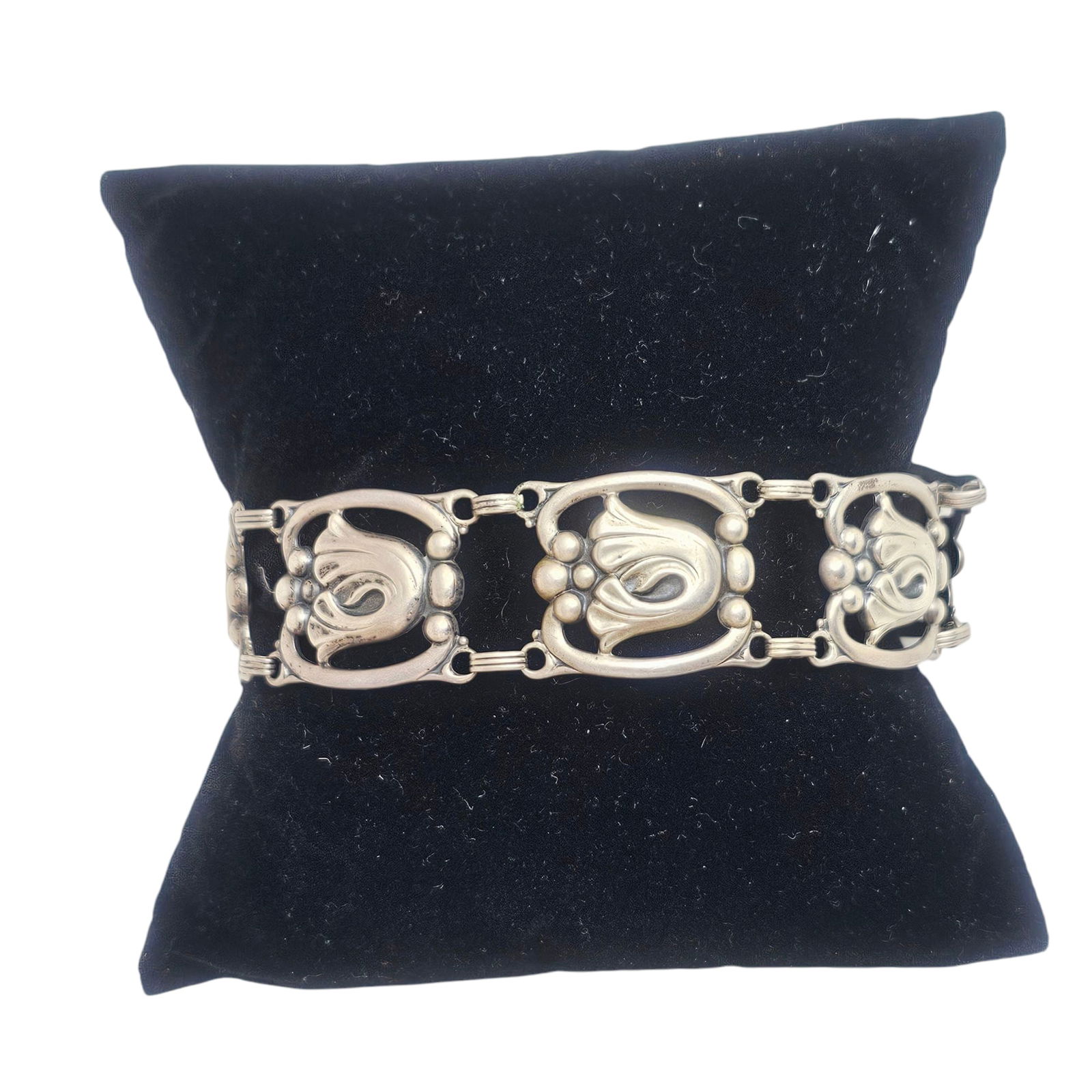 Modernist Sterling Silver Bracelet, Danecraft: The sterling silver foliate motif links completed by a hook and eye clasp forming a 7 inch bracelet. Marked "Danecraft." Gross weight: 26.0 grams. Absence of a condition report does