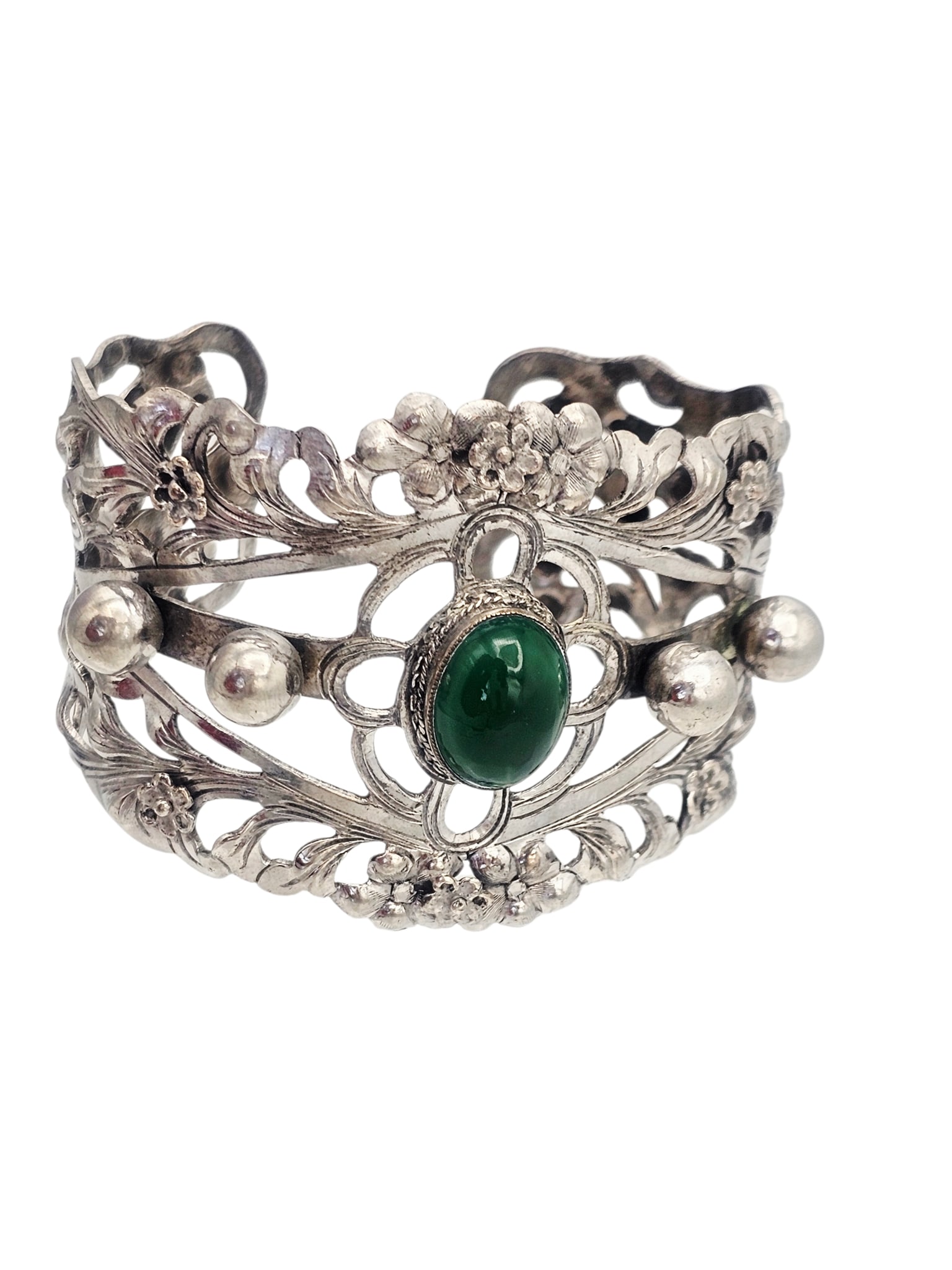 Agate, Sterling Silver Cuff Bracelet, Alice Caviness: Featuring an oval green agate cabochon measuring approximately 16.0 x 12.0 mm, set in a foliate motif, sterling silver cuff bracelet moun.ting measuring approximately 1.90 inches in width, interior