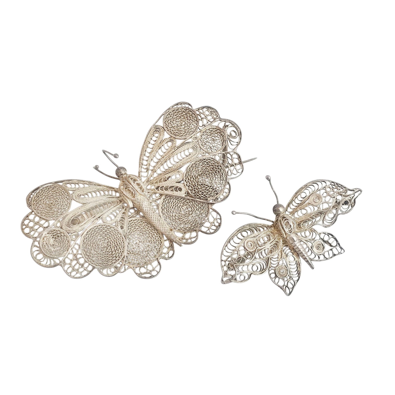 Collection of Two Chinese Export Silver Butterfly Pins: Each designed as a butterfly, on measuring approximately 9.45 x 4.93 cm (3.72 x 1.94 in), the second measuring approximately 6.53 x 3.00 cm (2.57 x 1.18in), set in silver filigree pin mountings.