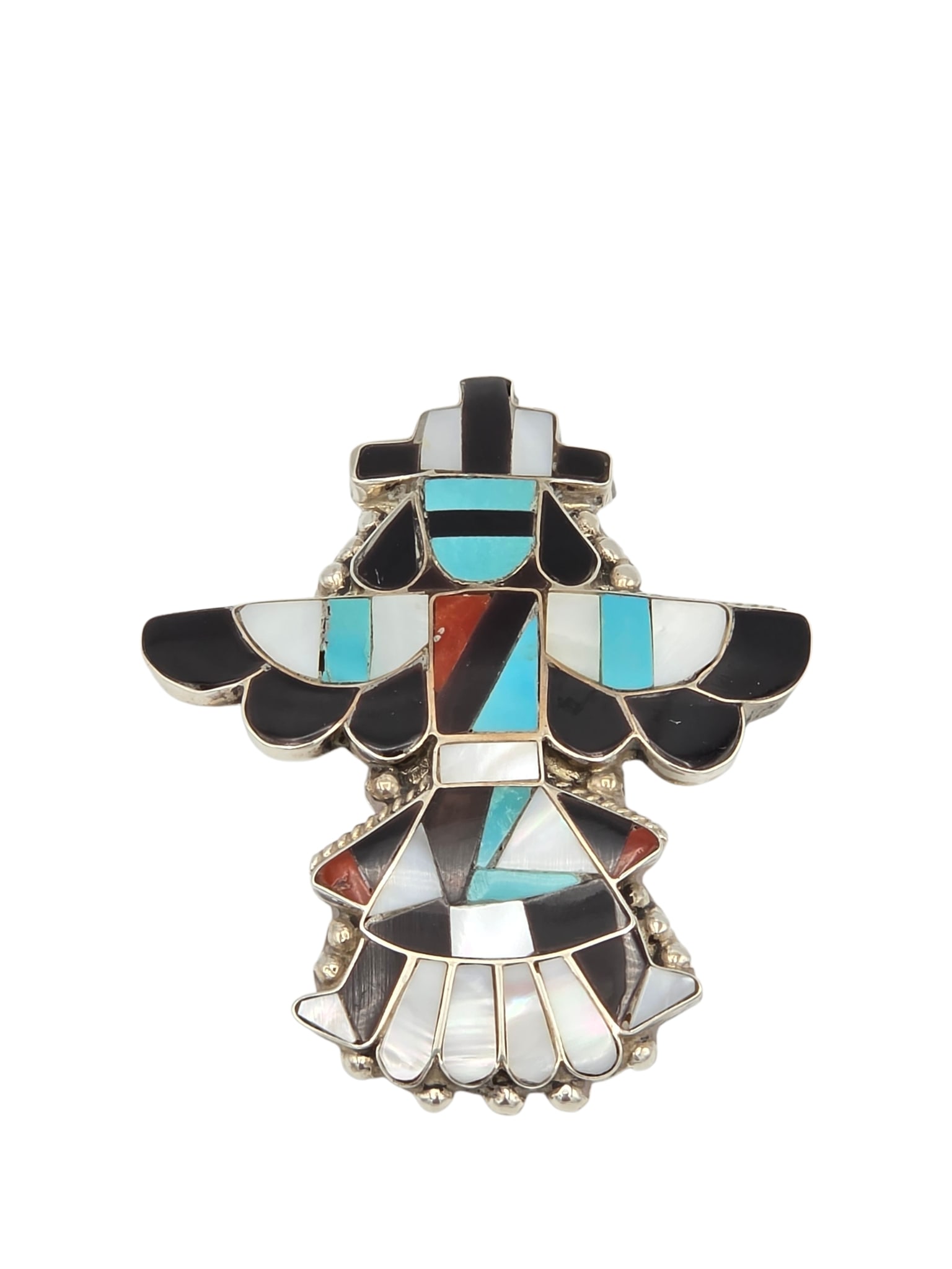 Zuni Style Multi-Stone, Sterling Silver Knifewing Dancer Pin Pendant: Designed as a Zuni Knifewing dancer highlighted by inlaid turquoise, jet, spiny oyster shell and mother-of-pearl, set in a sterling silver pin pendant mounting measuring approximately 2.30 x 1.80 inch