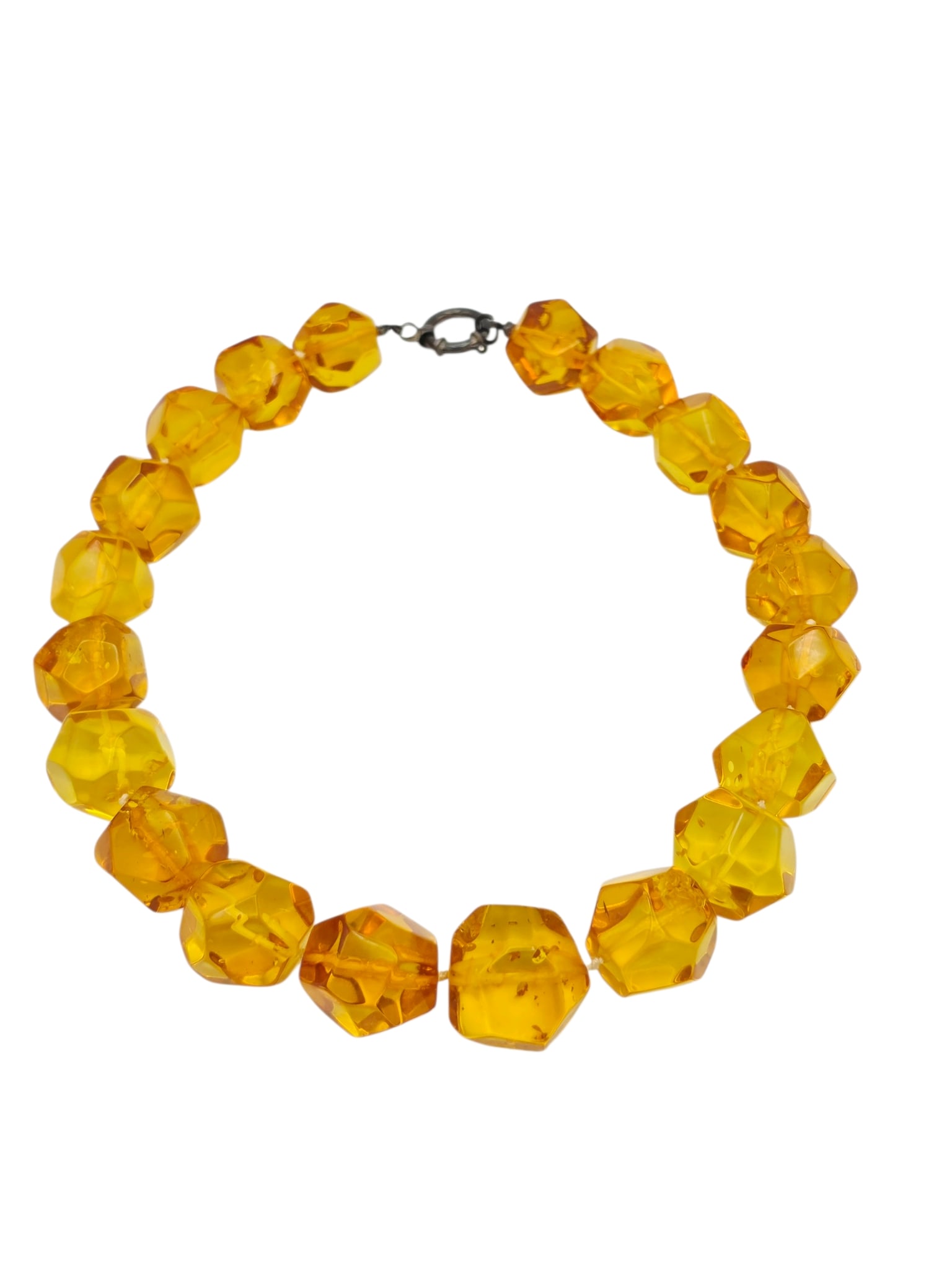 Amber, Blackened Silver Necklace: Composed of twenty faceted amber beads, measuring from approximately 25.0 to 19.0 mm, completed by a blackened silver spring ring clasp forming an 18 1/4 inch necklace. Gross weight: 104.2 grams.