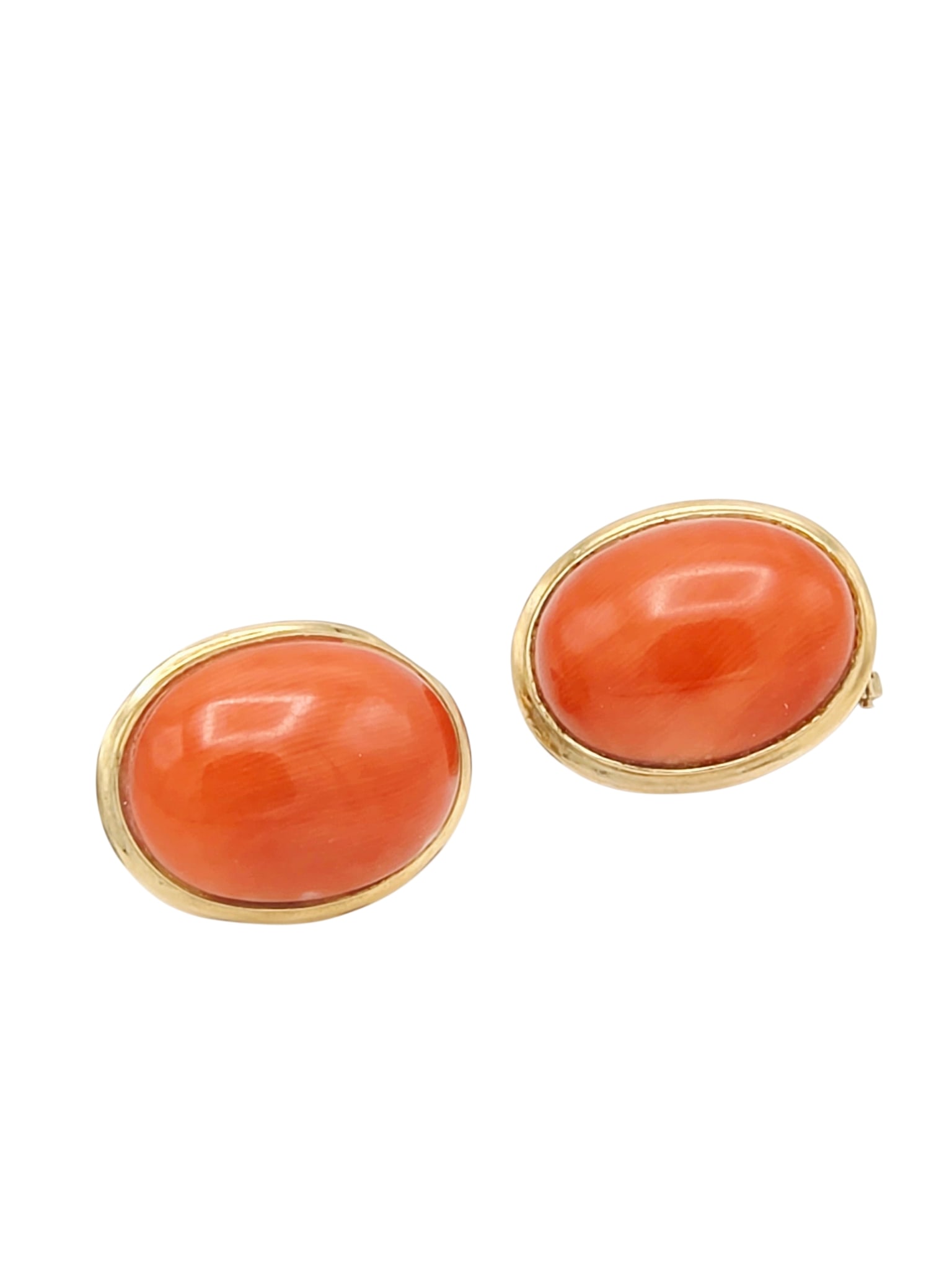 Pair of Coral, 14k Yellow Gold Earrings: Each centering one oval coral cabochon measuring approximately 15.0 x 11.5 mm, set in a 14k yellow gold earring mounting, Gross weight: 4.6 grams.
