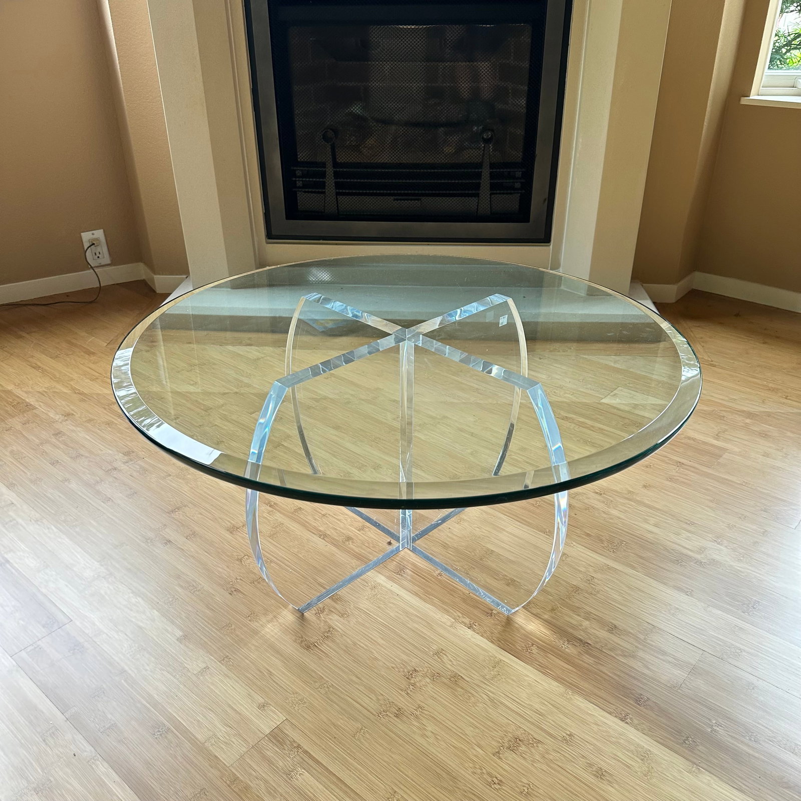 Mid-Century Style Lucite and Beveled Glass Coffee Table: A mid-century style acrylic coffee table with beveled glass top featuring heavy clear acrylic rounded base in an interlocking design with a round beveled glass top, unsigned. Measures