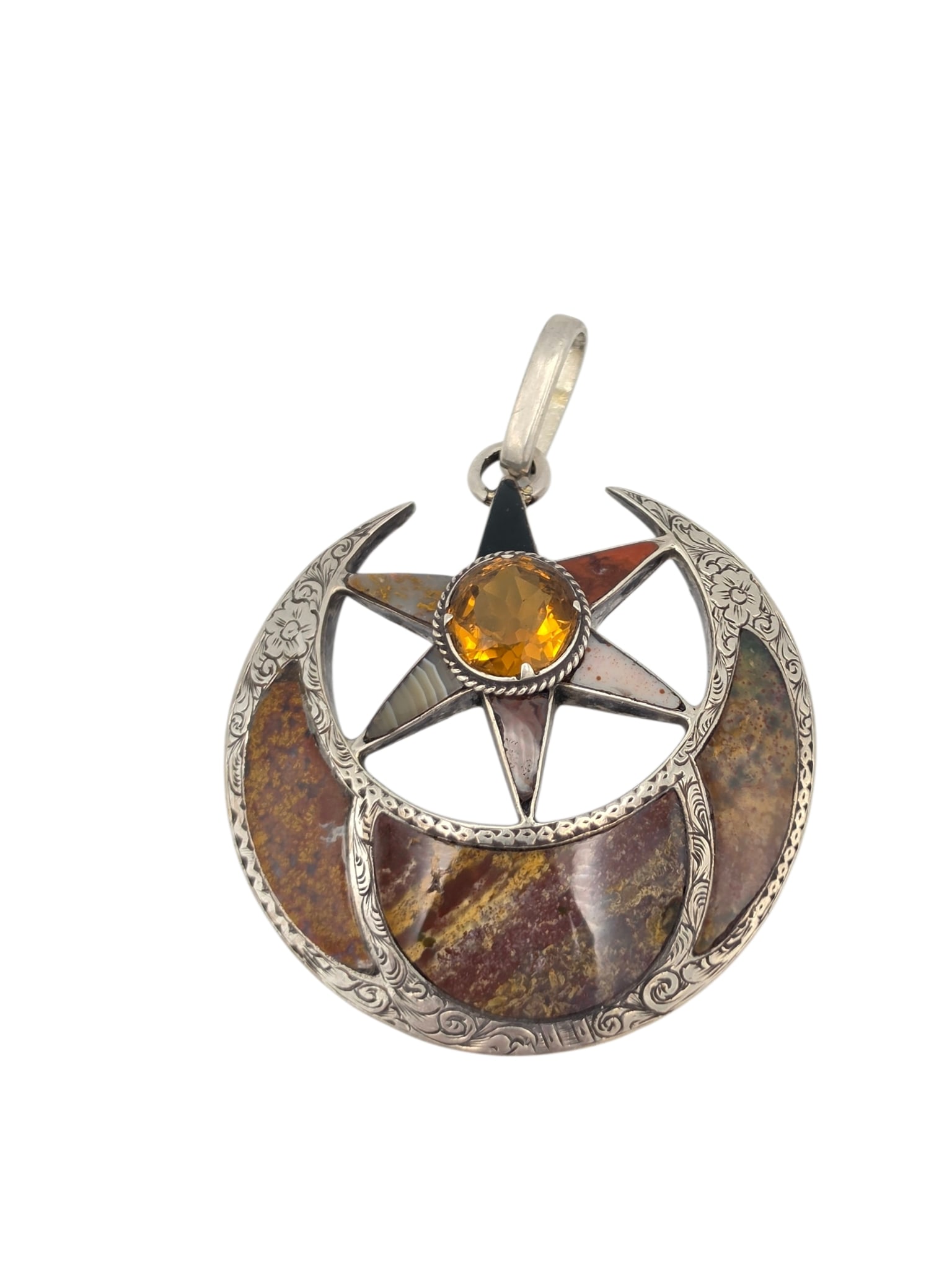 Victorian Scottish Agate Silver Pendant: Designed as a star within a crescent moon, centering one round 'cairngorm' citrine accented by various inlaid agates, set in an engraved, sterling silver pendant mounting measuring