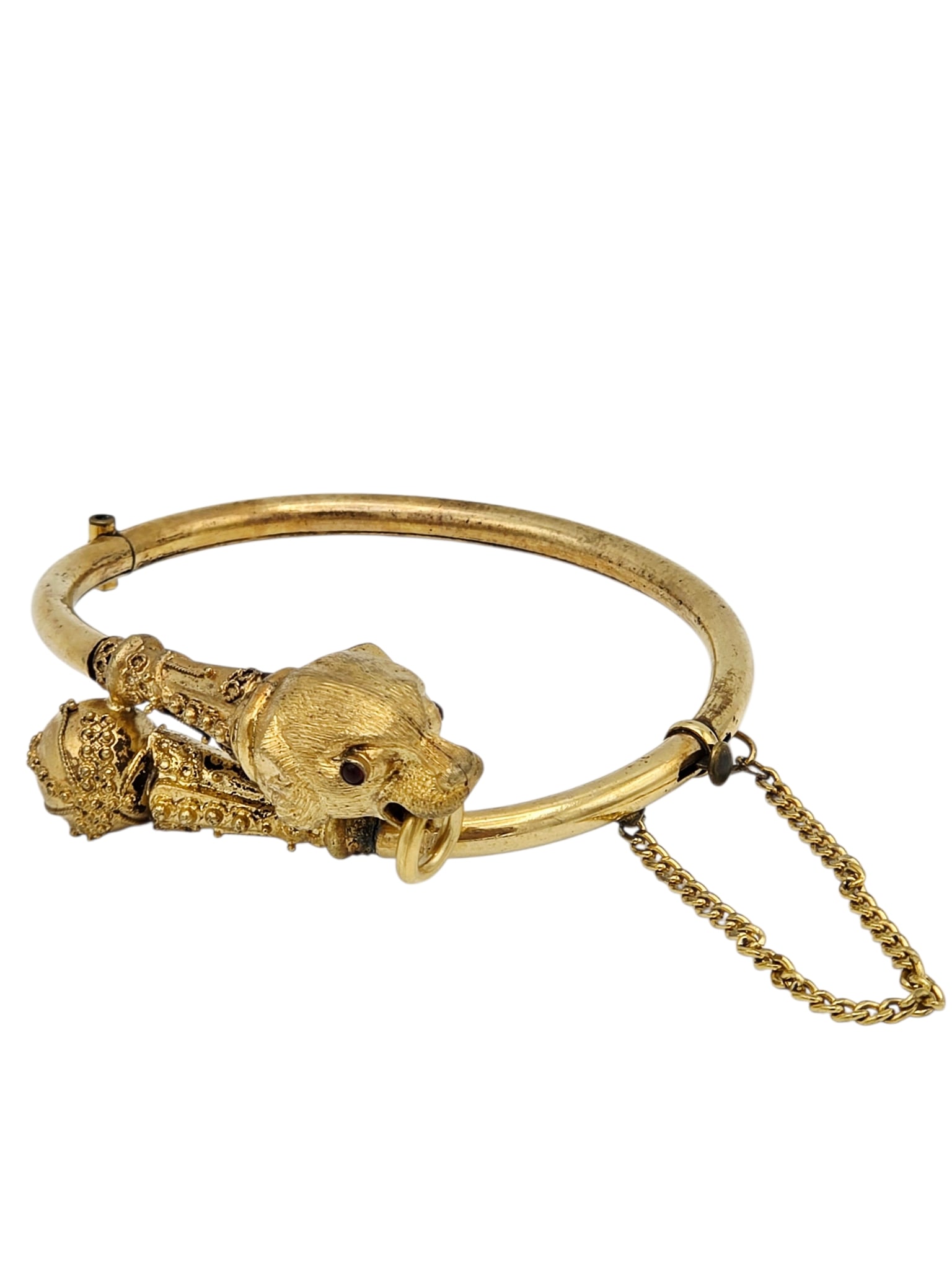Victorian Gold-Filled Lion's Head Bracelet: Designed as a lion, the eyes two round-cut garnets, set in a granulated, by-pass style bracelet mounting, completed by a push-button tongue-and-groove clasp with safety chain, inner circumference 6