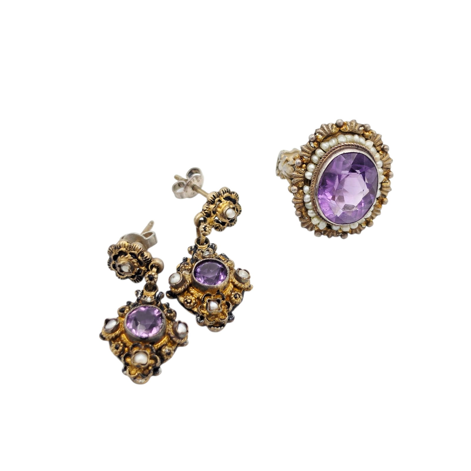 Austro-Hungarian Amethyst, Seed Pearl, Silver Gilt Jewelry Suite: Including a ring featuring one oval-cut amethyst weighing approximately 9.15 cts., framed by seed pearls, set in an ornate, silver gilt ring mounting, size 7; together with a pair of earrings, each fe