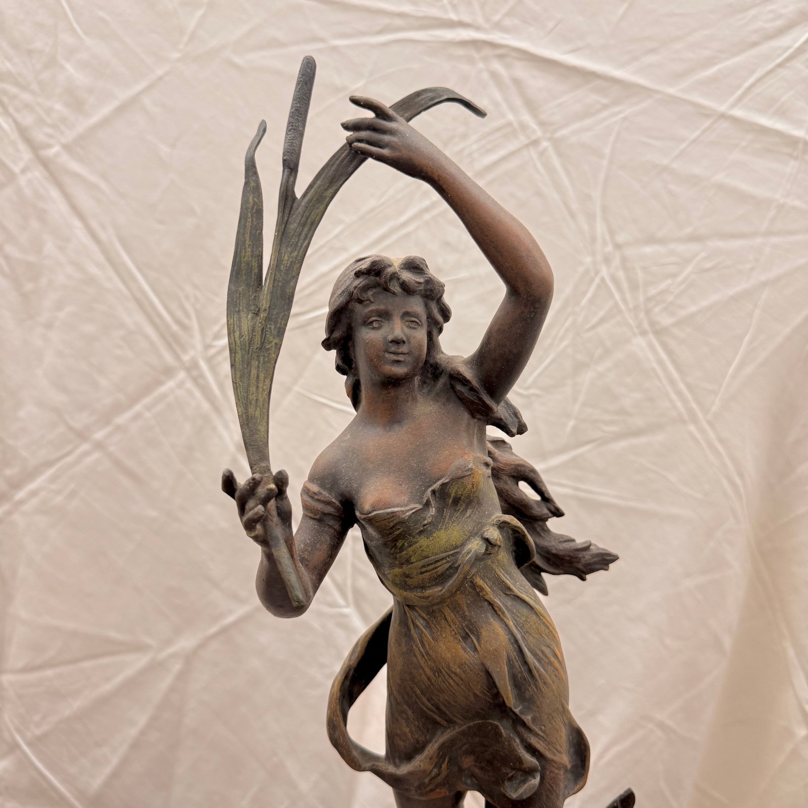 After Henryk Kossowski (1855-1921) "Naiade" Statue: After Henryk Kossowski (1855-1921) "Naiade" Art Nouveau spelter sculptural figure of the water nymph holding river reeds and cattails, standing atop stones. Plaque on base reads "Naide