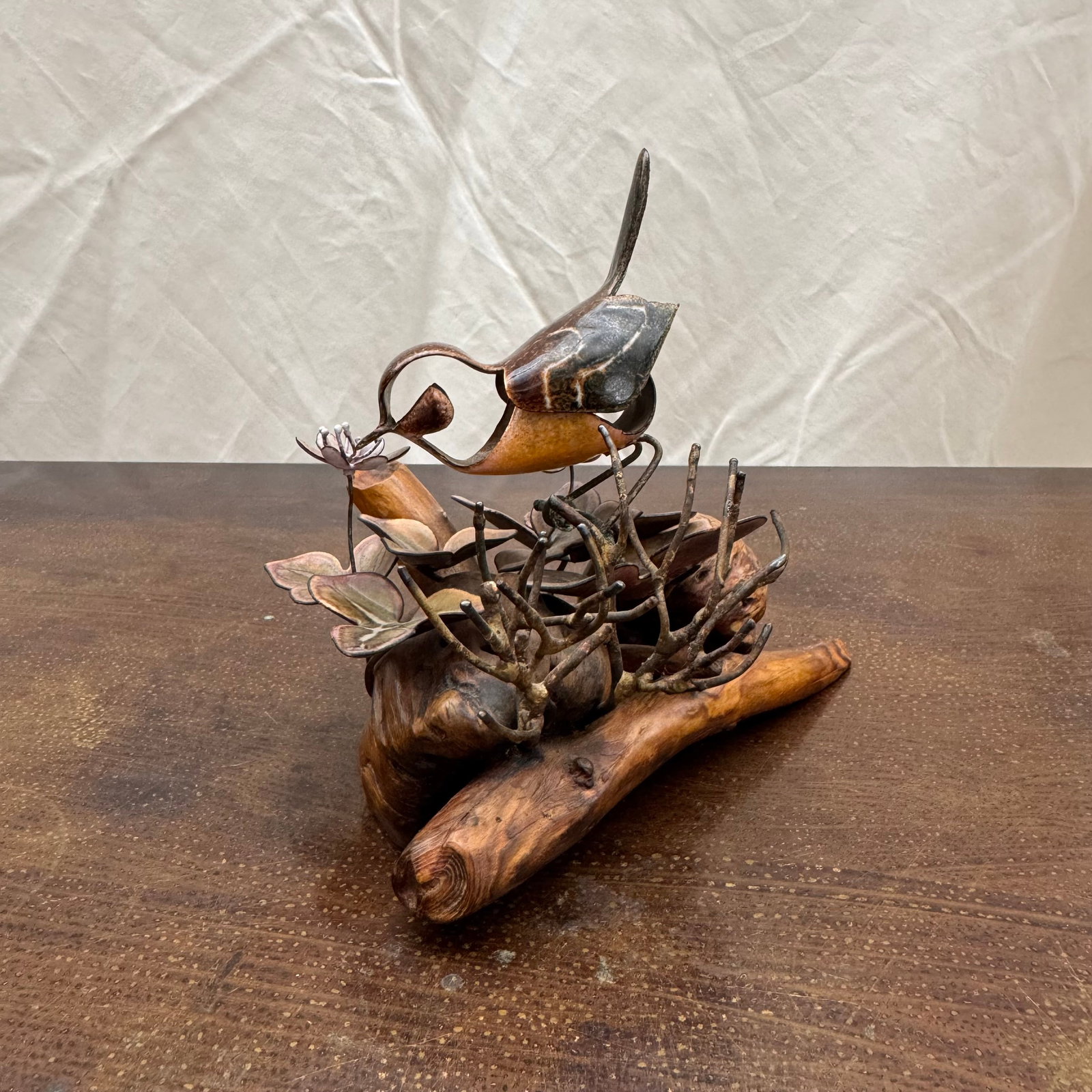 Enamel metal bird sculpture on Burl wood, Signed: Enamel bird and foliage sculpture on driftwood, signed.