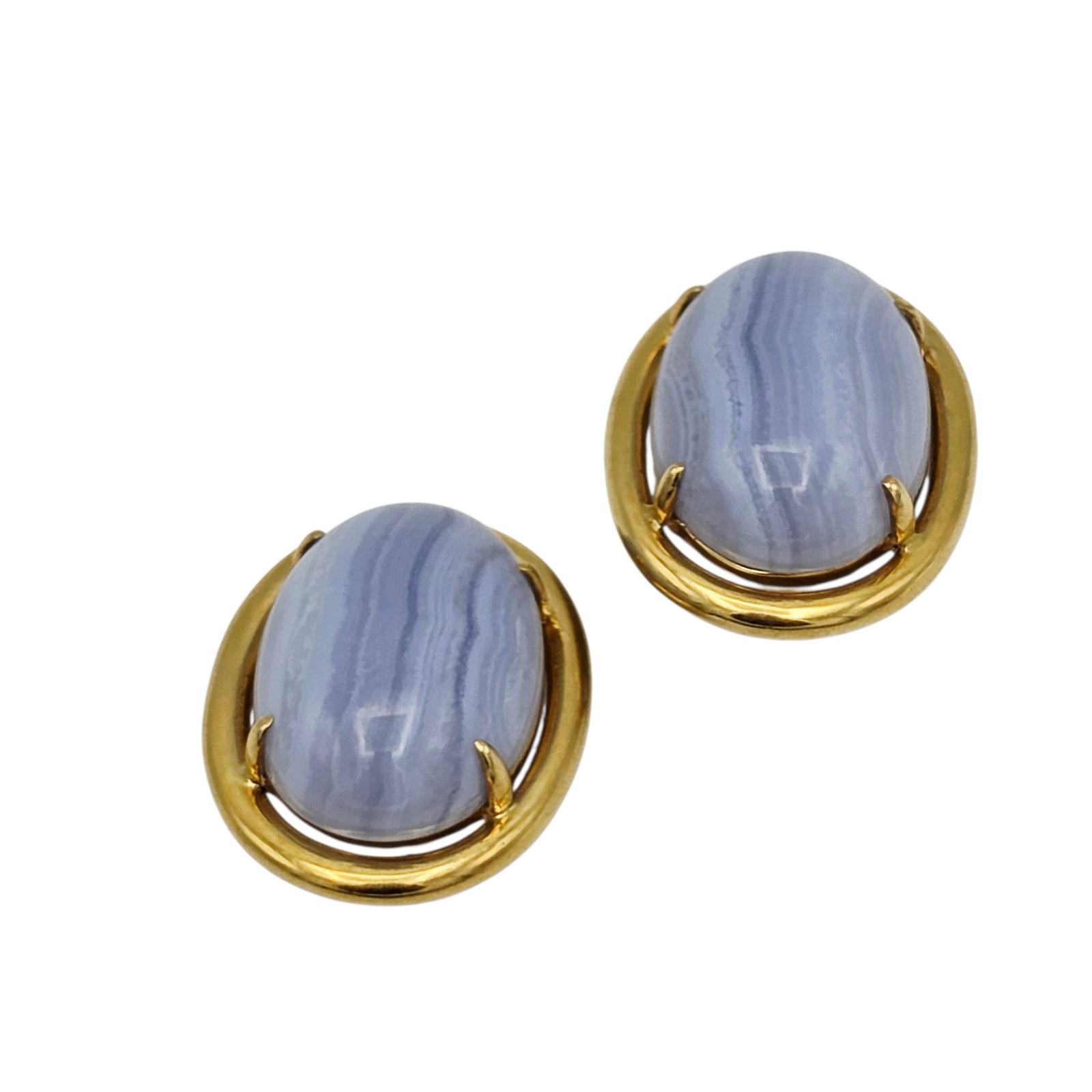 Pair of Agate, 14k Yellow Gold Ear Clips, Gump's: Featuring an oval agate cabochon set in a 14k yellow gold ear clip mounting measuring approximately 1.20 x 0.95 inches. Marked: '14k, Gump's.' Gross weight: 27.3 grams.