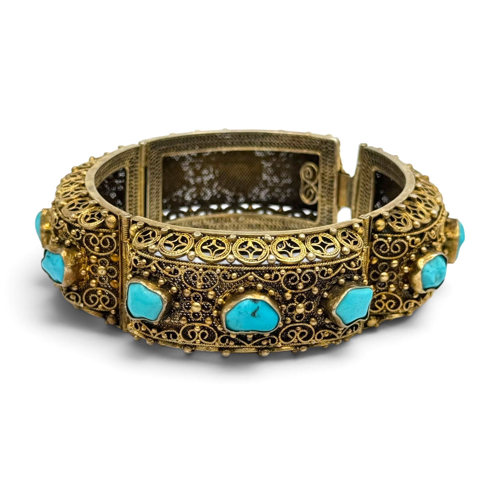 Chinese Export Turquoise, Silver Gilt Bracelet: Featuring twelve tumbled turquoise set in an articulated, silver gilt mounting measuring approximately 23.0 mm in width, completed by a hidden, push-button tongue-and-groove clasp forming a 6 3/4