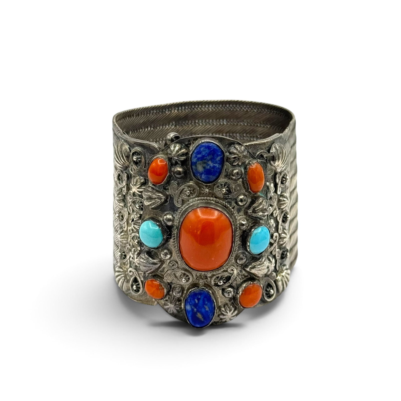 Himalayan Coral, Lapis Lazuli, Turquoise, Silver Bracelet: Centering one oval coral cabochon measuring approximately 20.0 x 15.4 mm, highlighted by coral, lapis lazuli and turquoise cabochons, set in a silver clasp with applied embellishments and hidden