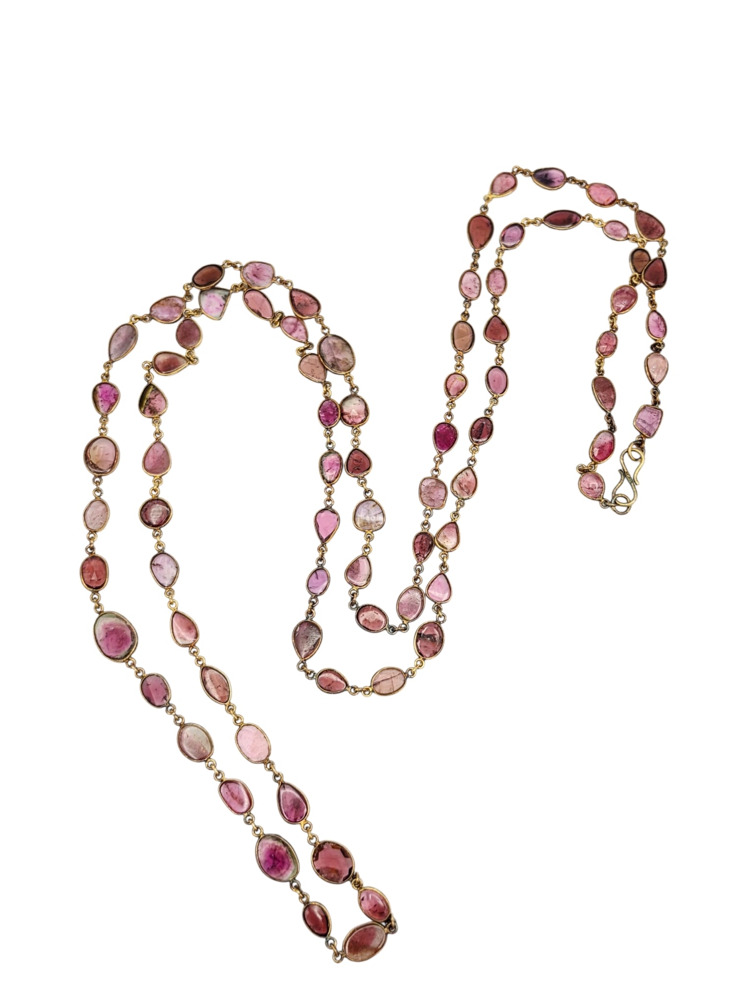 Tourmaline, Silver Gilt Necklace: Featuring seventy-eight pink and bi-color tourmalines set in sterling silver gilt mountings completed by a 'S' hook clasp forming a 48 inch necklace. Gross weight: 29.0 grams.