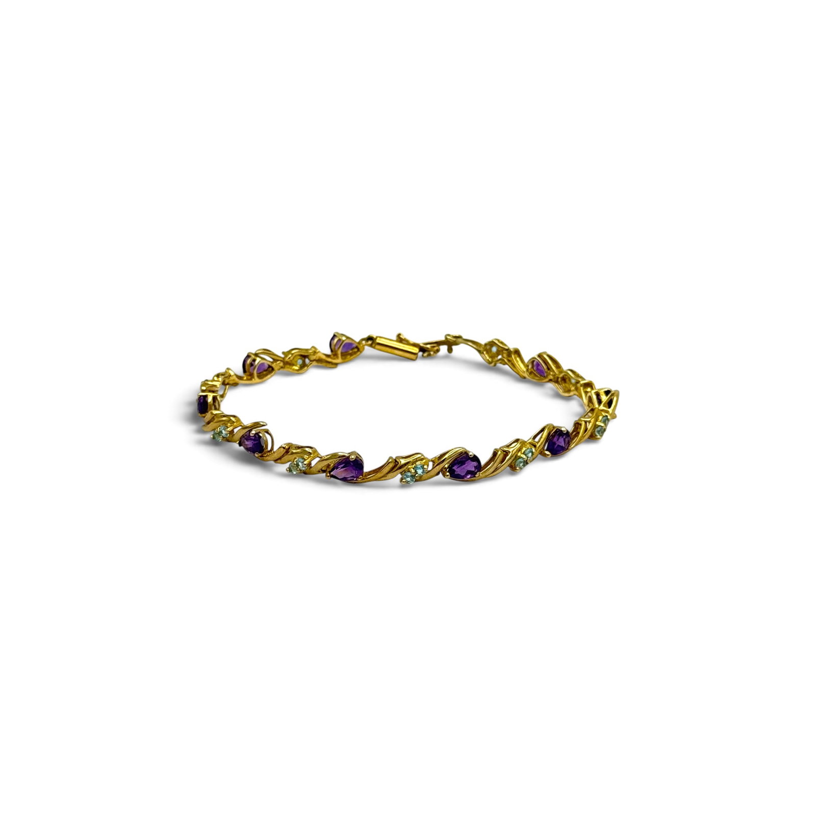 Amethyst, Blue Topaz, 10k Bracelet: Featuring nine pear-cut amethyst weighing a total of approximately 4.50 ctw., accented by eighteen round-cut blue topaz weighing a total of approximately 0.72 ctw., set in an articulated, 10k yellow