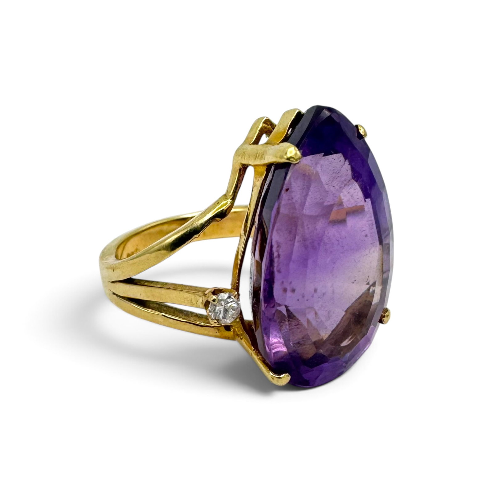 Amethyst, Diamond, 14k Yellow Gold Ring: Featuring one pear-shape amethyst weighing approximately 21.05 cts., accented by two round brilliant-cut diamonds weighing a total of approximately 0.12 ctw., set in a 14k yellow gold ring mounting,