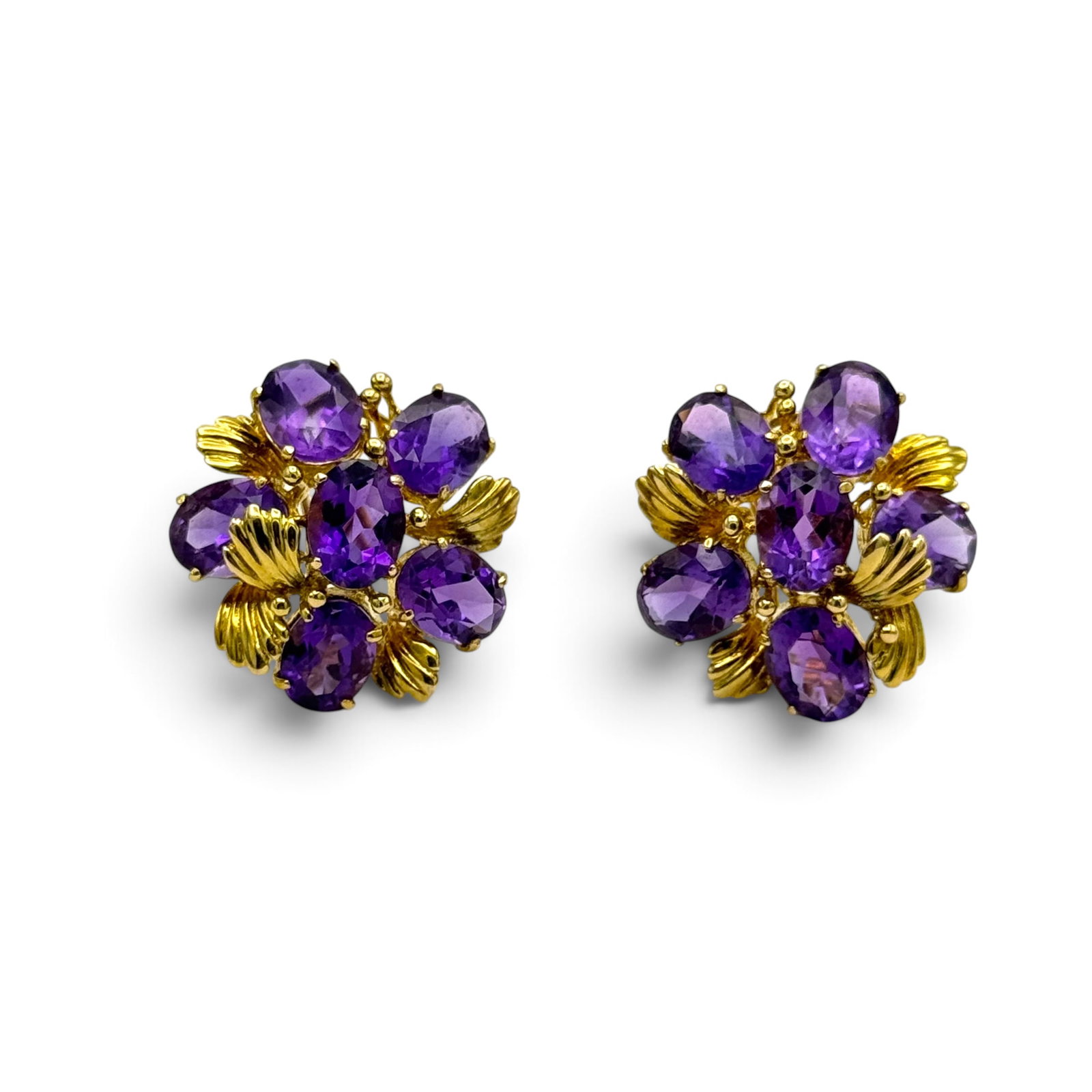 Pair of Amethyst, 14k Yellow Gold Earrings: Designed as a flower interspaced by leaves, each featuring six pear-shape amethyst weighing a total of approximately 7.05 ctw.,, set in a 14k yellow gold earring mounting measuring approximately