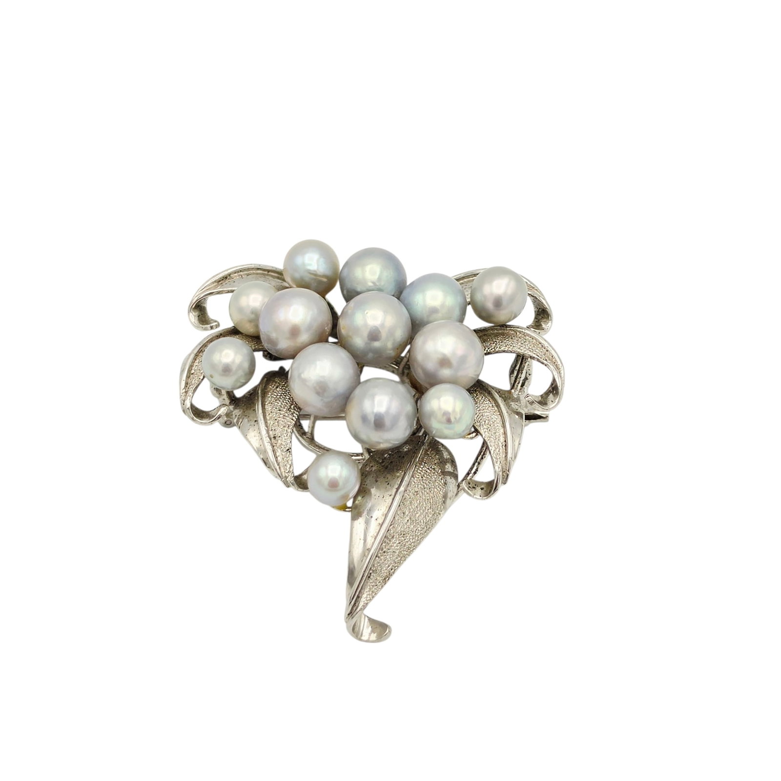 Cultured Pearl, Sterling Silver Spray Brooch: Designed as a spray, featuring thirteen near round cultured pearls measuring from approximately 9.0 to 6.0 mm, set in a sterling silver pin mounting measuring approximately 1.90 x 1.70 inches. Gross