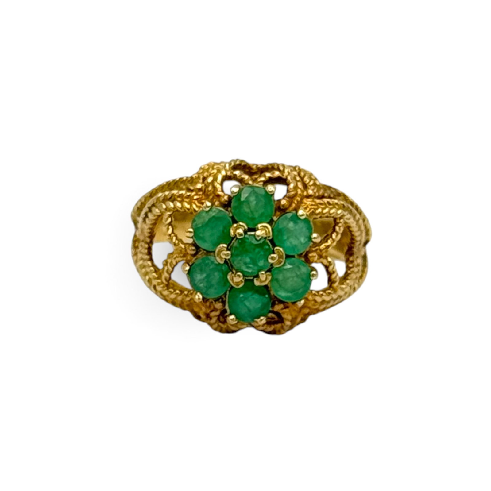 Emerald, 10k Yellow Gold Ring: Featuring seven round-cut emeralds weighing a total of approximately 1.05 ctw., set in a ropework, 10k yellow gold ring mounting, size 7 1/2. Gross weight: 5.0 grams.
