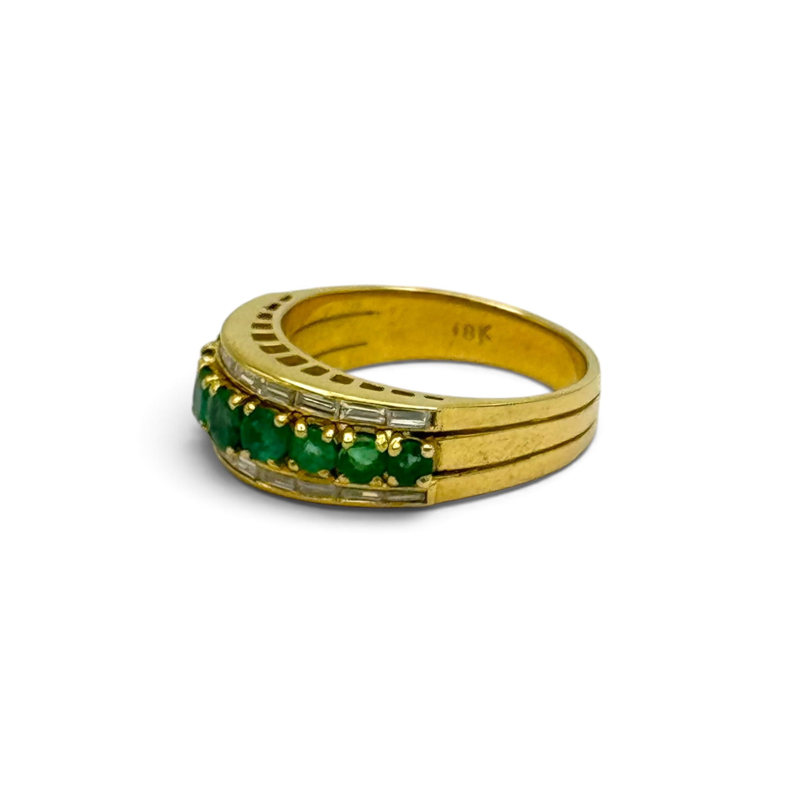 Emerald, Diamond, 18k Yellow Gold Ring: Centering nine round-cut emeralds weighing a total of approximately 1.25 ctw., accented by twenty baguette-cut diamonds weighing a total of approximately 0.60 ctw., set in an 18k yellow gold ring moun