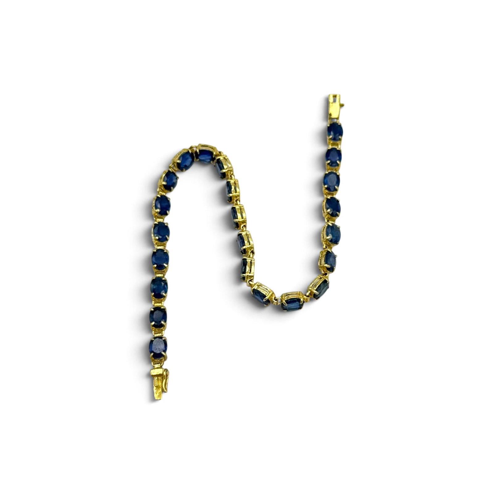 Sapphire, 14k Yellow Gold Bracelet: Featuring twenty-three oval-cut sapphires weighing a total of approximately 11.50 ctw., set in an articulated, 14k yellow gold mounting completed by a tongue-and-groove clasp with figure-eight
