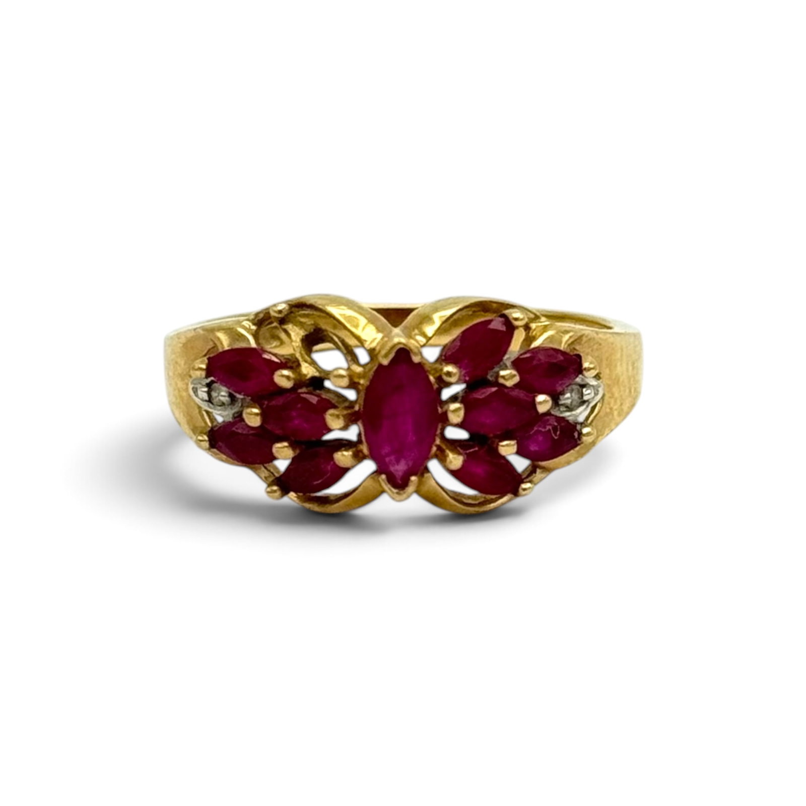 Ruby, Diamond, 10k Yellow Gold Ring: Featuring ten marquise-shape rubies weighing a total of approximately 1.15 ctw., accented by two single-cut diamonds weighing a total of approximately 0.02 ctw., set in a 10k yellow gold ring