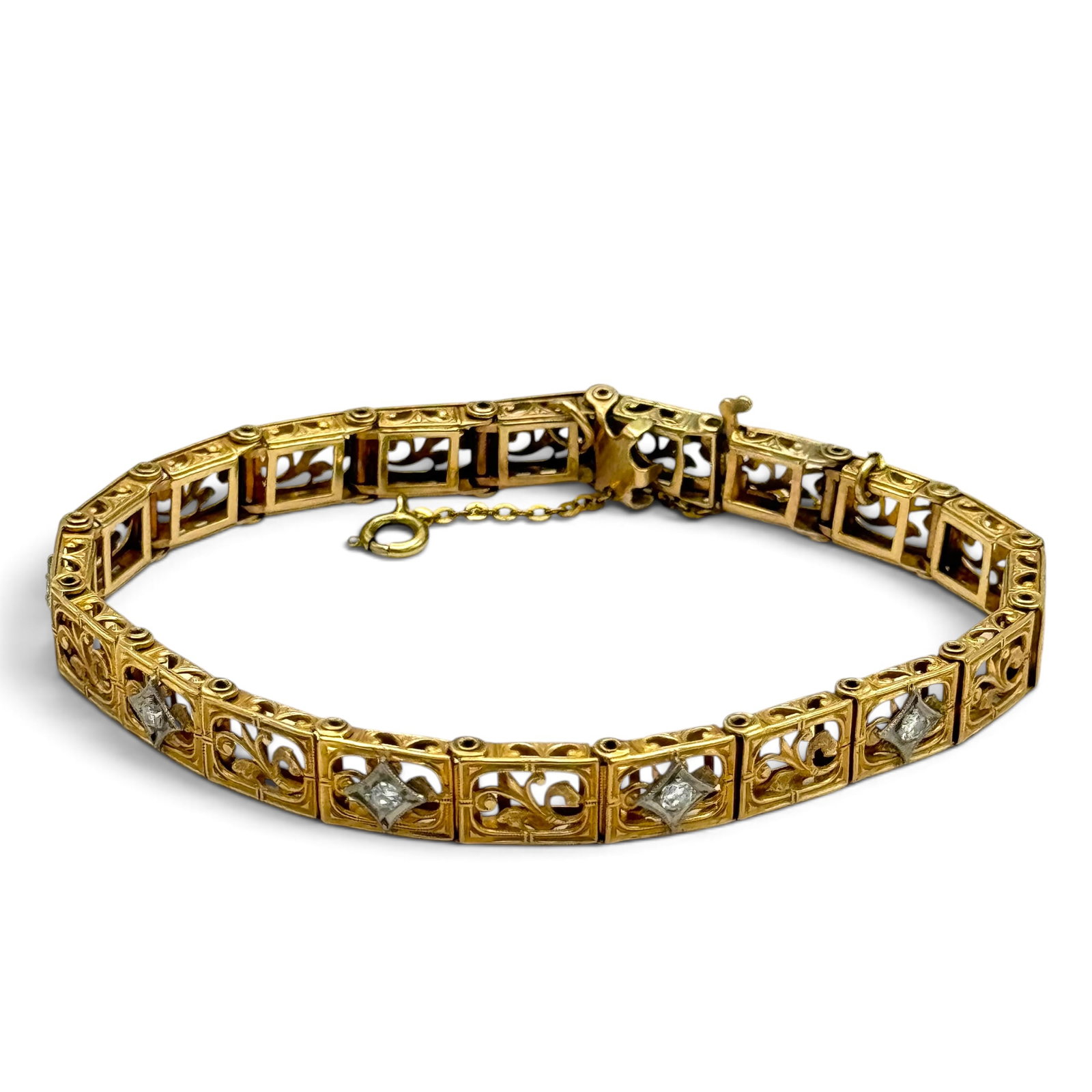 Diamond, 10k Yellow Gold Bracelet: Featuring five full-cut diamonds weighing a total of approximately 0.35 ctw., set in a pierced, foliate motif, 10k yellow gold articulated mounting, completed by a hidden tongue-and-groove clasp with