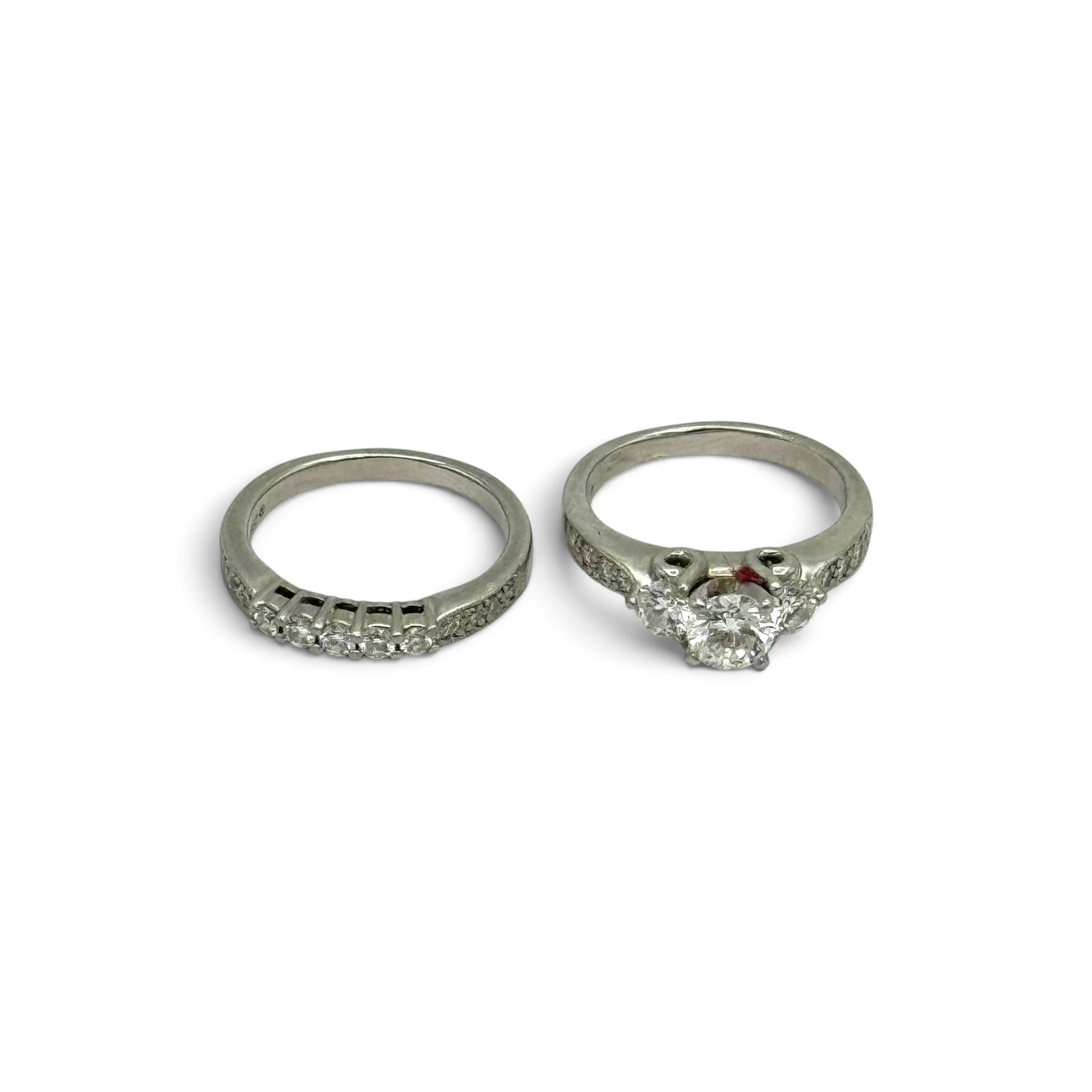 Diamond, Platinum Wedding Set: Including one ring centering one round brilliant-cut diamond weighing approximately 0.58 ct., accented by ten round brilliant-cut diamonds weighing a total of approximately 0.34 ctw., set in a platinu