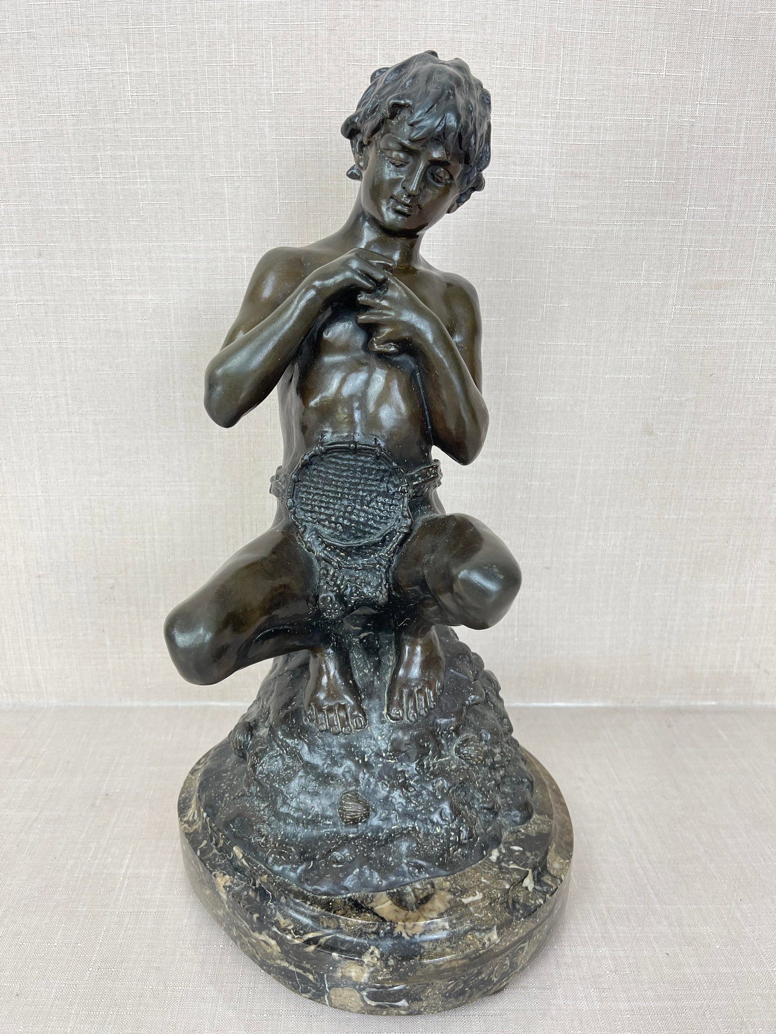 "Boy on Rock with Fish" by T. Campajola, Bronze: Good condition. Ht: 14.5" on marble base.