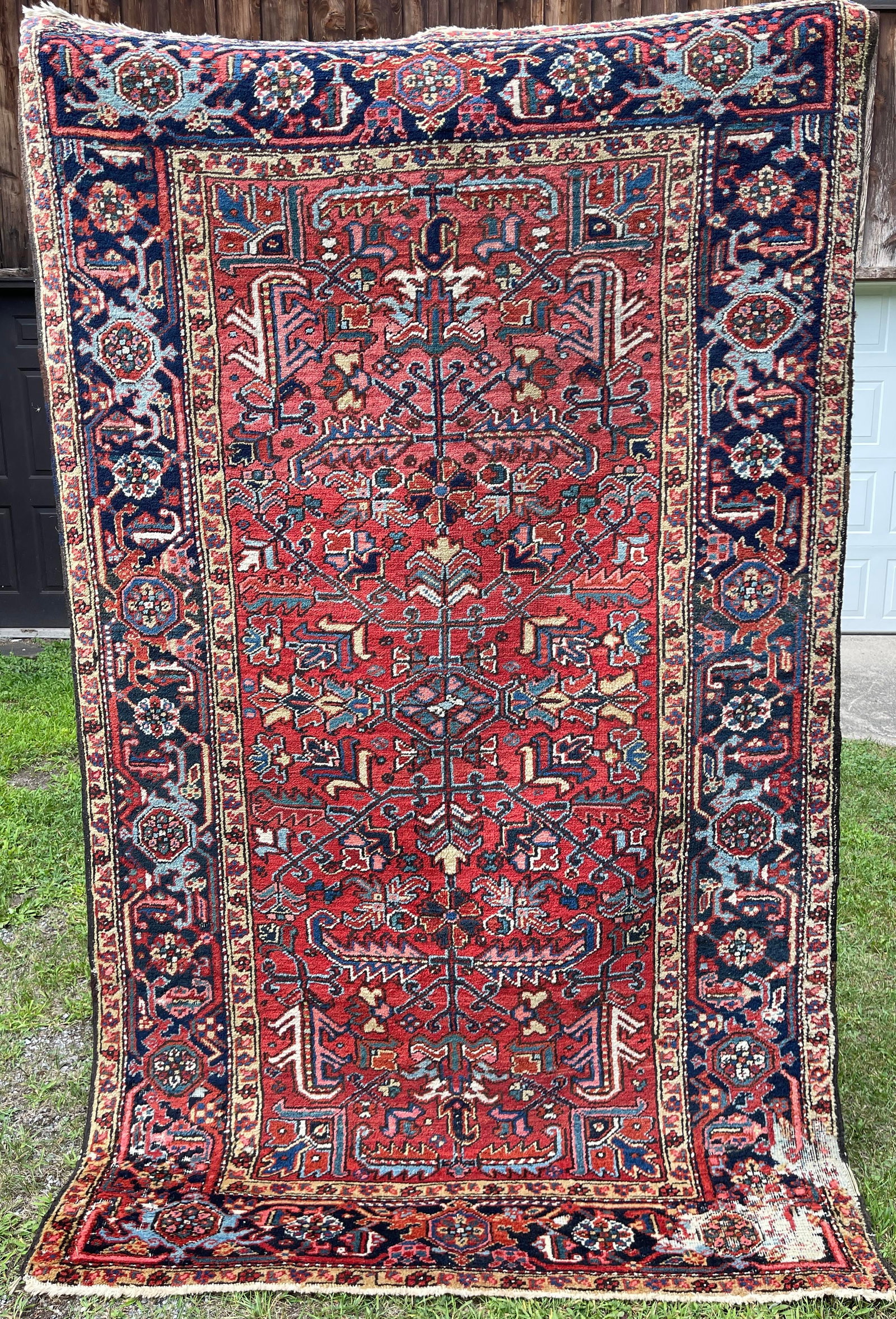 Antique Persian Heriz: Significant insect damage to one corner. Otherwise good condition. 8'1" x 5'