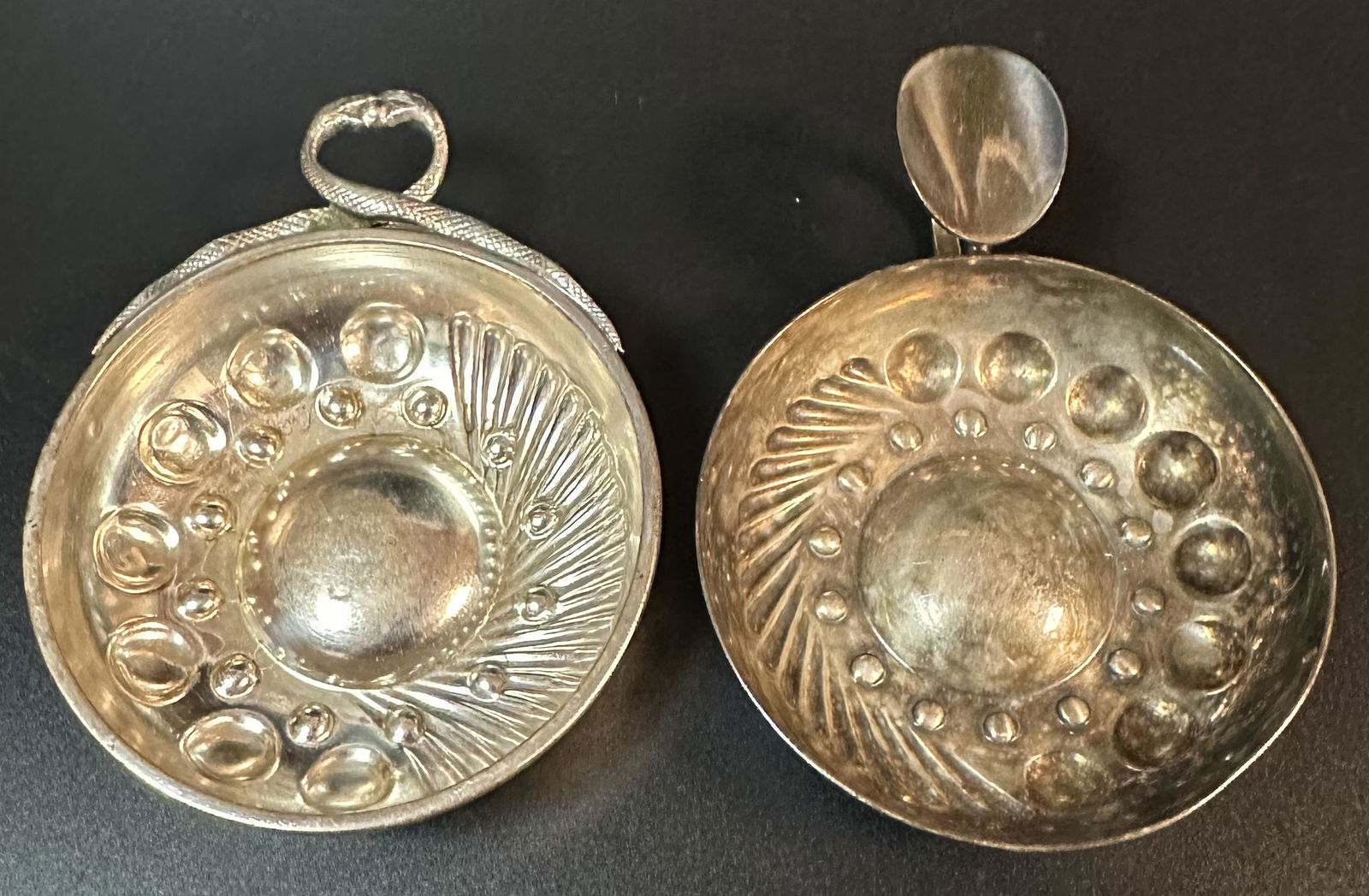 Pair Silver French Tastevin Wine Tasters Christofle: Two French silver tastevins. One is marked Christofle on the handle and the one with the snake handles is a reproduction of an 18th Century tastevin. Total silver weight is about 3.7 Troy ounces.