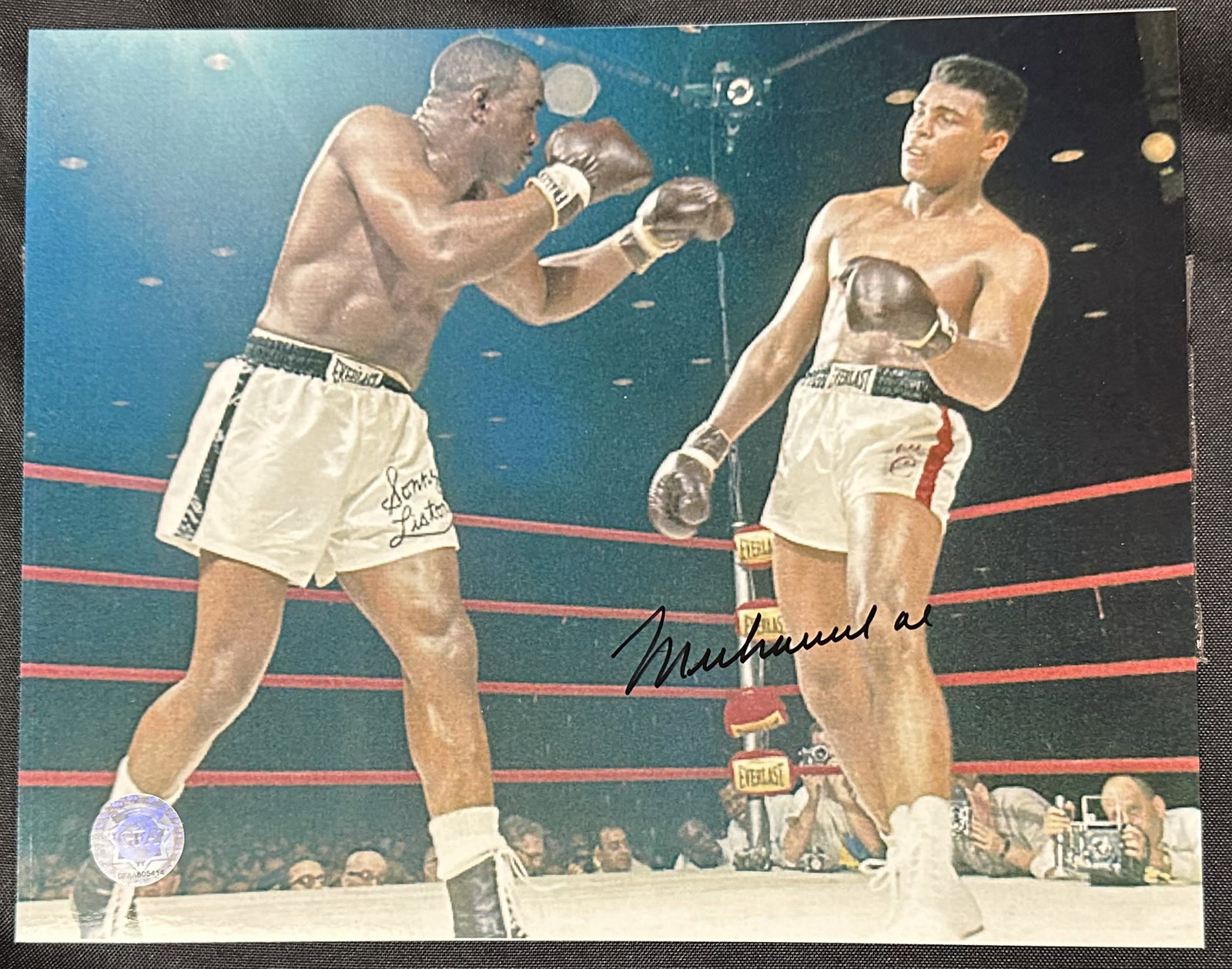 Muhammad Ali with Cert: Terrific photo of the great Muhammad Ali in action signed across his legs. The signature has been certified authentic and comes with the documentation.