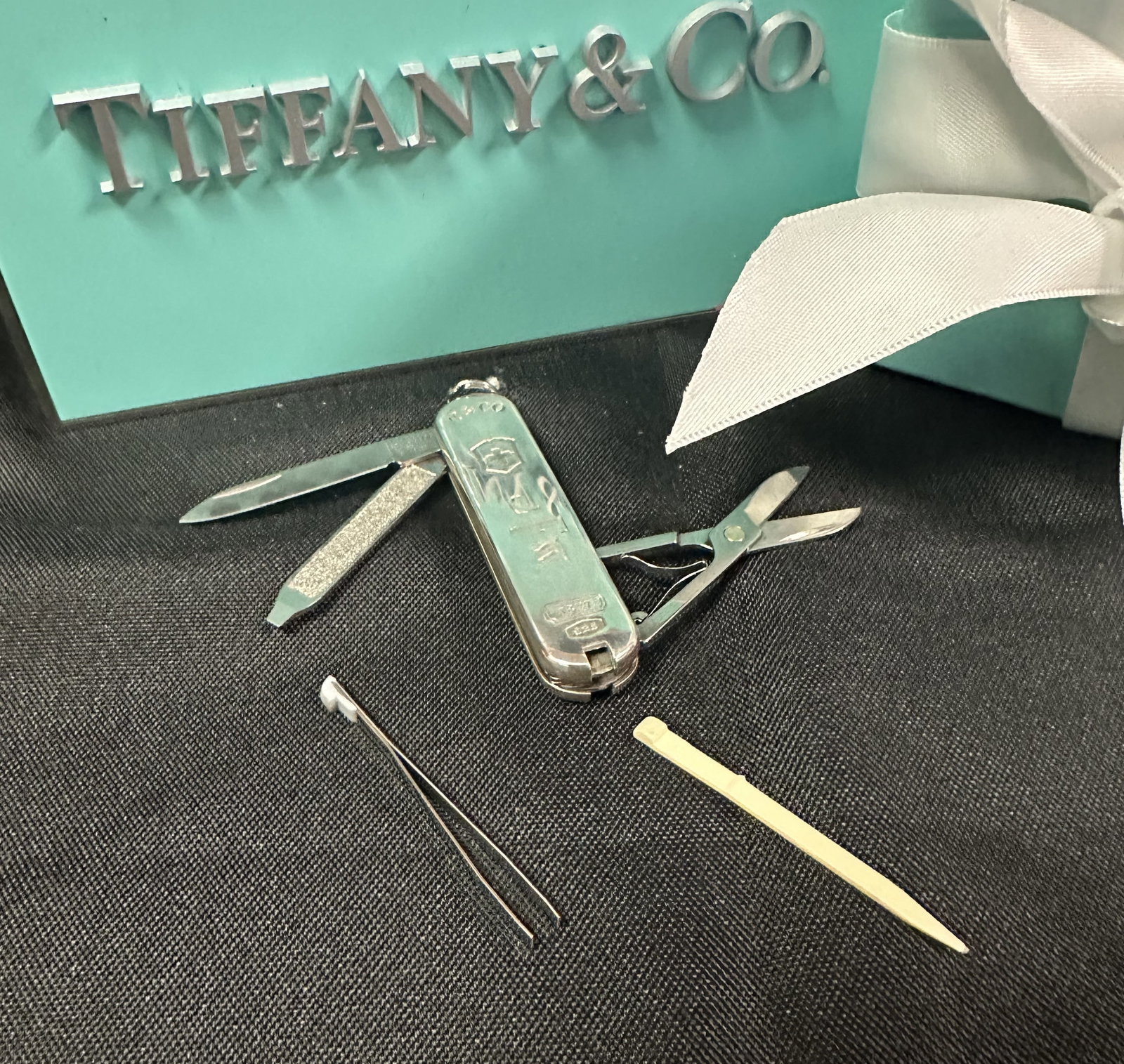 Tiffany Sterling Silver Swiss Army Pocket Knife: Tiffany sterling silver Swiss Army knife with a kinfe blade, file, scissors, tweezers and a brand new (replaced) plastic tooth pick. Please see picture for al lmarks and engravings. This piece comes w