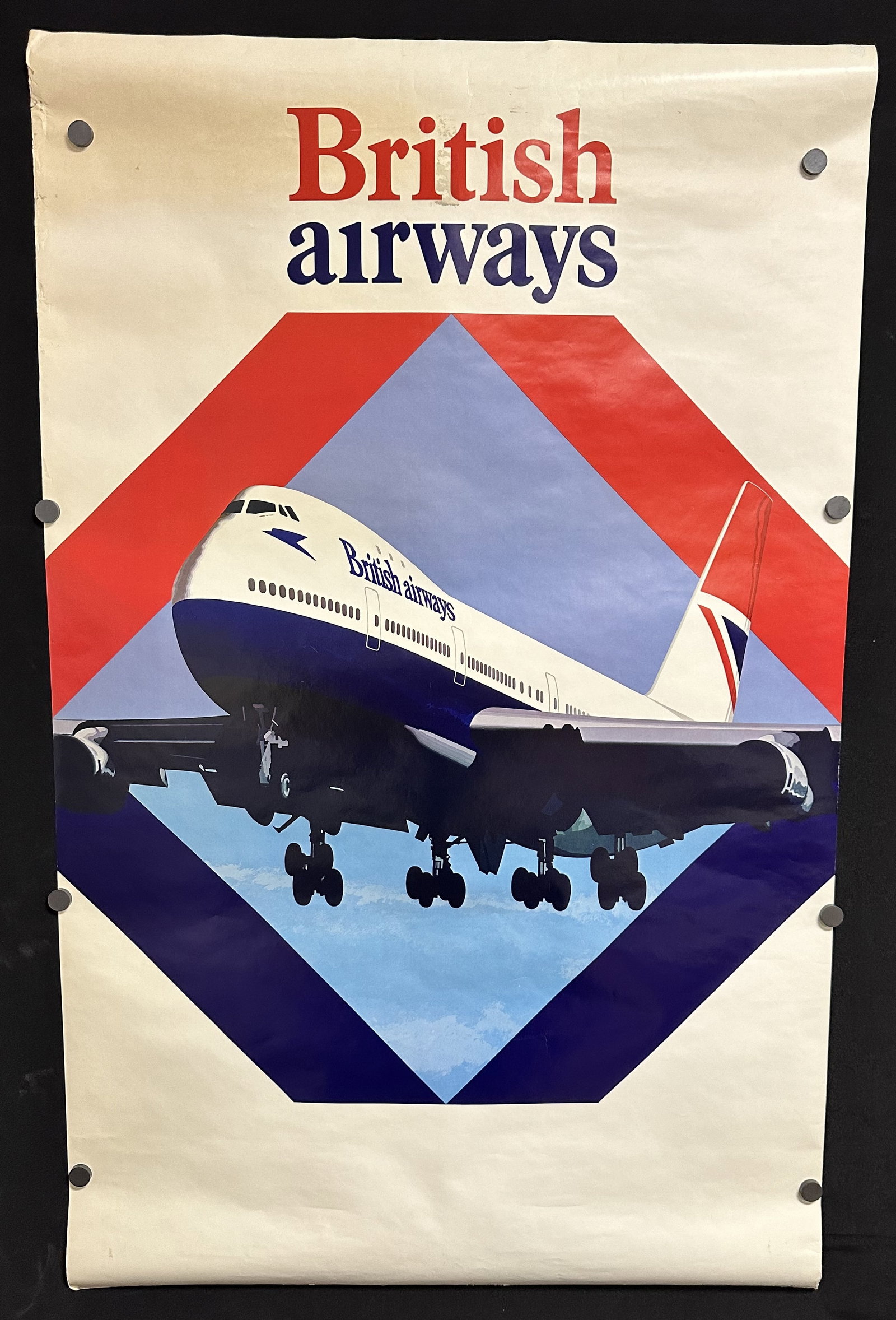British Airways Rare Original Vintage Graphic Poster: Fantastic illustrated image for British Airways circa 1977. This is a hard to find poster depicting a jetliner coming straight out of the poster. Bold colors, distinctive design and use of negative sp