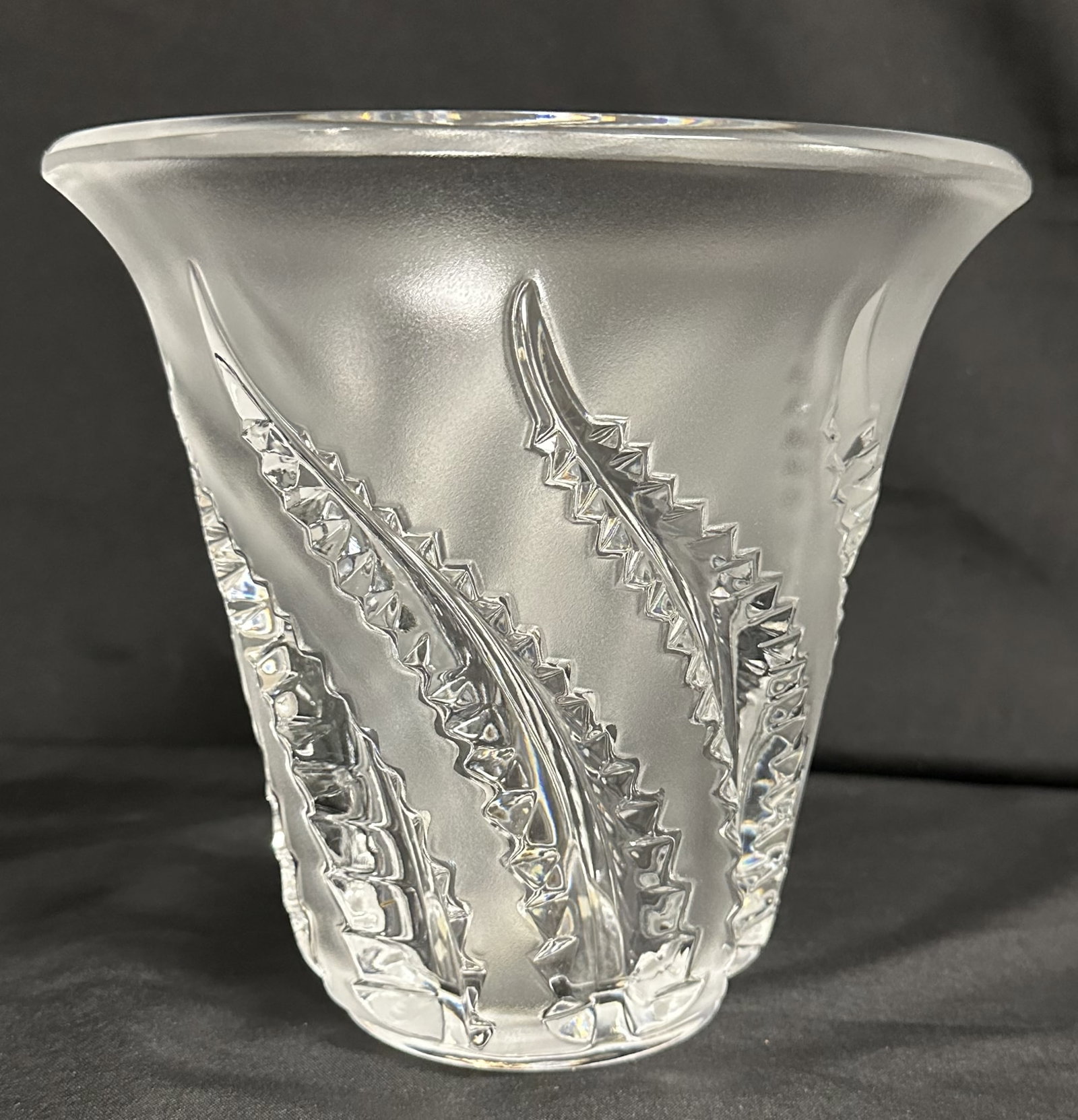Lalique Lobelia Fern Vase: Lalique Lobelia vase in clear and frosted crystal with a repeating leaf pattern covering the body, 7 1/2in. H x 8in. W (rim), 3 1/2in. W (base). Etched signature. Paris, France.