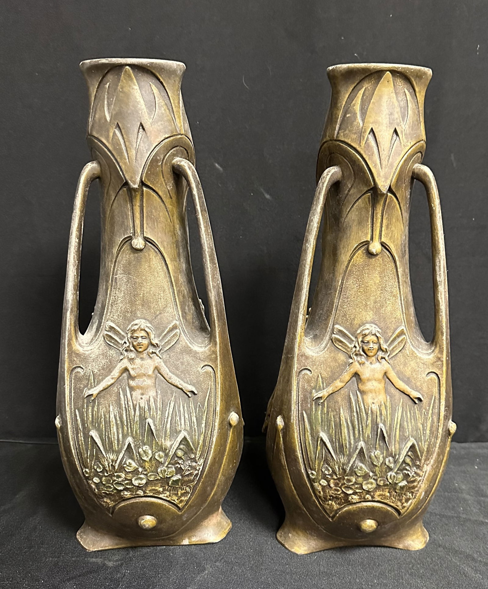 Pair of Art Nouveau Bronze Patinated Vases by J. Garnier, France, 1900: 19th century Art Nouveau vases by J. Garnier. Three panel sides with beautiful detailed high relief winged Fairies, flora and fauna. Each panel signed by J. Garnier (1853-1910) J. Garnier was a noted