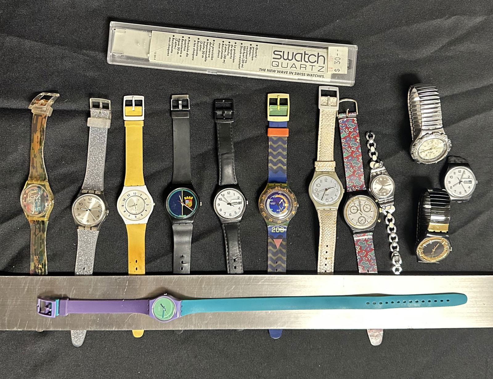 Lot of 13 Vintage Swatch Watches: Great group of 13 swatch watches (all untested) of all kinds shapes and colors with an original Swatch box as well.