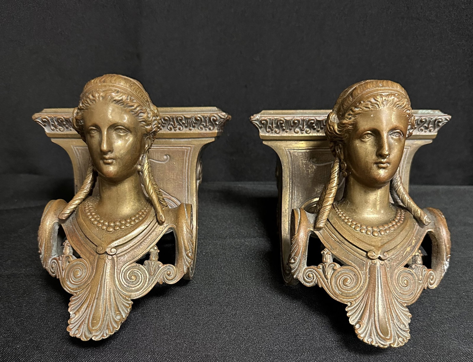 Pair of Bronze Grecian Style Corners: Beautiful and well made bronze Grecian style pieces measuring about 5 1/2 inches tall but that doesn t take into account the swoop of the angle below the head and the heft of the overall piece. An ama