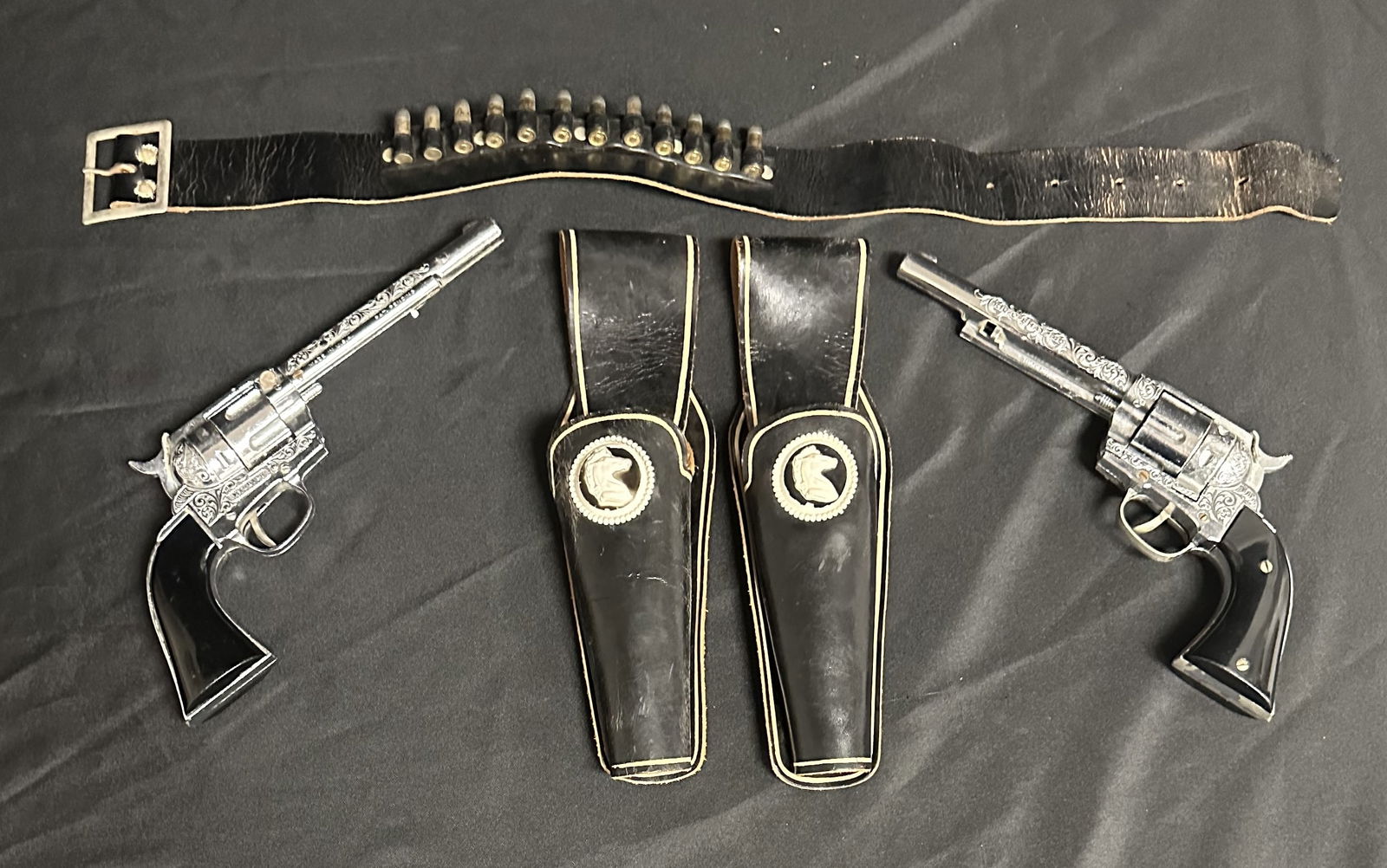 Hubley Pair of Cap Gun Pistols with Holster and Belt: Best pair of toy cap guns I ve ever had. Hubley full size cap guns with fancy belt and holsters. This is the first one I ve ever seen where they have removable bullets for the child to really immerse